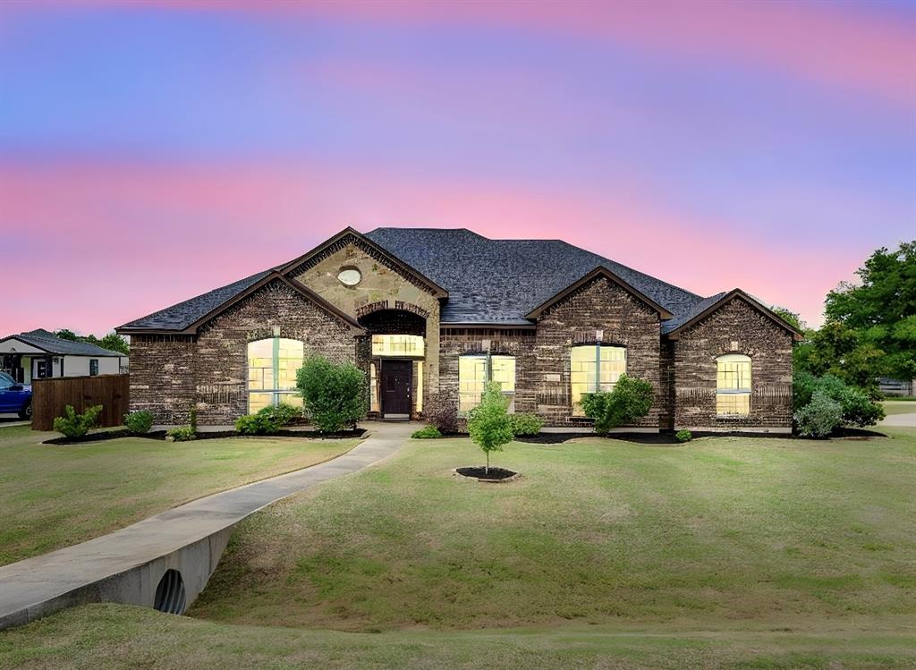 COUNTY TAXES AND NO HOA! CORNER LOT ON OVER HALF AN ACRE! Situated on a little over a half acre corner lot, this meticulously maintained 2,741 sq. ft.home offers 3 bedrooms WITH AN OFFICE! Office has a closet and could also serve as a 4th bedroom. Built in 2014 and recently refreshed with new paint and landscaping! The Sellers fenced in the backyard and removed all carpet when they moved into the home. This home offers warm, natural light throughout. Decorative lighting, durable luxury vinyl plank flooring with tile flooring in the kitchen and bathrooms. Spacious kitchen offers ample space for all your cooking needs with beautiful wood cabinets, a large island, an electric cooktop, a refrigerator, a stainless steel dishwasher, oven, and built-in microwave. The kitchen seamlessly flows into the eat in breakfast nook as well as into the formal dining area. Relax by the wood-burning fireplace on a cold winter night in the cozy living room, or retreat to the  private office for a quiet workspace. The functional split-bedroom layout includes a primary suite, two additional bedrooms, and an office. The sunny laundry room includes a wash sink and an electric dryer. The home internet service is through Starlink and the water system is through the Rocket Special Utility District. Outside, enjoy the freedom of a massive, fenced-in backyard with an extended back patio. There is a plum tree, a peach tree, a pomegranite tree, and plenty of room for chickens to roam! Also plenty of room to add a shop or a pool! Endless possibilities with no HOA! The 3-car garage offers room for all your vehicles or just a place to tinker. Located in the sought-after Waxahachie ISD and just minutes from local shopping, eateries, and entertainment, this property combines small-town charm with everyday convenience. Schedule your showing today! We'd love to show it to you!