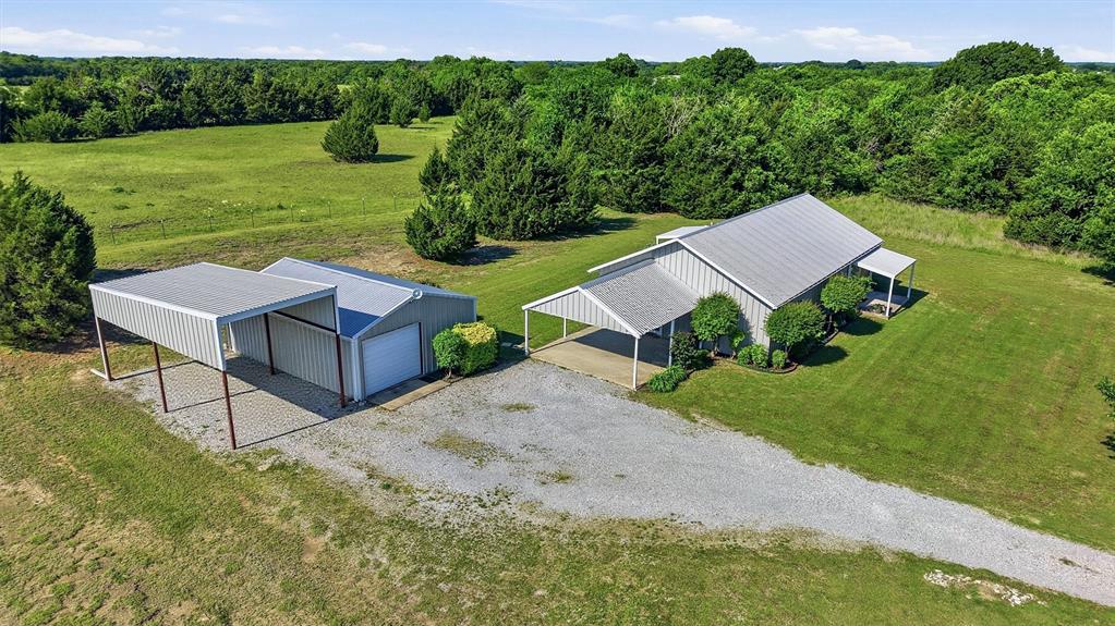 Country charm meets convenience at 15656 State Highway 78 N in Blue Ridge! Nestled on just over 2 acres, this custom barndominium offers peaceful rural living with easy access to nearby growth areas. Built in 2015, the home features approximately 1,500 sq ft of living space with an open-concept design full of rustic character and flexibility. Can be used as a 3 Bedroom and large den or office, or easily 4 bedrooms. Full spray foam keeps the temperature comfortable year round. The property is ideal for those looking for space to spread out, enjoy the outdoors, or create the perfect hobby farm setup. Wide open views, mature trees, and a scenic setting make this property feel private while still being located on a paved state highway. Located in Trenton ISD with no HOA, this unique property offers endless potential for full-time living, weekend retreat, or investment opportunity. Check out the very best of the back yard neighbors.