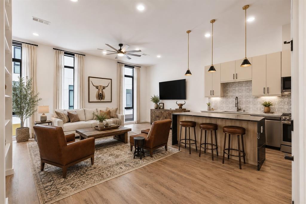 Experience elevated urban living in this modern, corner-unit townhome located in the heart of Fort Worth, just moments from Magnolia Avenue, South Main, and TCU’s medical school campus. Thoughtfully designed across three levels, this residence blends sophisticated architecture with refined luxury and exceptional functionality. Each floor features a private bedroom and bath, offering the ideal layout for guests, roommates, or multi-generational living. The expansive main living level is anchored by a dramatic waterfall island, quartz countertops, sleek custom cabinetry, and premium stainless steel appliances — all seamlessly connected to an open-concept living and dining space designed for effortless entertaining. Retreat to the secluded third-floor primary suite, where a custom walk-in closet and spa-inspired bath create a true sanctuary. Indulge in dual sinks, a freestanding soaking tub, and frameless glass shower. A conveniently located third-floor laundry room enhances everyday living. The rooftop patio delivers breathtaking panoramic views of the Fort Worth skyline, offering an unforgettable setting for entertaining or relaxing under the city lights. Additional upscale features include electronic shades throughout, privacy window film, and a tandem garage with epoxy flooring. With no HOA and short-term rentals permitted, this exceptional property presents a rare opportunity for both luxury living and investment potential in one of Fort Worth’s most dynamic locations.