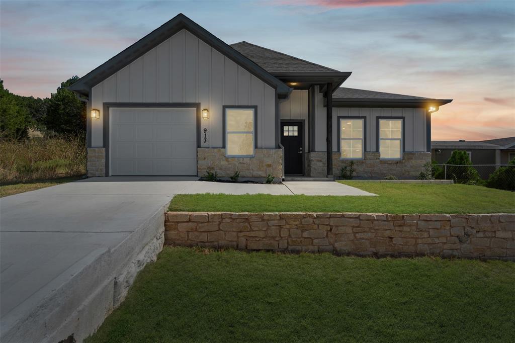 Step into this beautifully designed brand-new home in Comanche Cove, Granbury, where modern comfort and thoughtful craftsmanship meet. With 3 bedrooms, 2 bathrooms, 1,395 square feet of living space, and a 1-car garage, this home is the perfect blend of style, functionality, and convenience. As you enter, you’re greeted by an open floor plan that seamlessly connects the living, dining, and kitchen areas, creating a warm and inviting atmosphere for everyday living and entertaining. The kitchen is equipped with modern cabinetry, sleek finishes, and an efficient layout that makes cooking and gathering easy. The spacious living area is highlighted by contemporary light fixtures and large windows that allow natural light to fill the space, making the home feel bright and welcoming. The primary suite offers a private retreat with its own ensuite bathroom, providing both comfort and convenience. Two additional bedrooms offer flexibility whether you need space for family, guests, or a home office. Both bathrooms feature clean, modern designs with quality finishes that complement the home’s fresh, updated style. Outside, the property includes a 1-car garage for parking or storage, along with a yard that’s ready for your personal touch whether you envision a garden, play area, or outdoor entertaining space. Located in Comanche Cove, this home offers a peaceful neighborhood feel while keeping you connected to all that Granbury and the surrounding area have to offer. Enjoy quick access to downtown Granbury, known for its historic square, shopping, dining, and entertainment, as well as easy routes to Glen Rose, home of Dinosaur Valley State Park and other local attractions. This new build is move-in ready and waiting for its first owners. Whether you’re searching for your very first home, a downsizing opportunity, or simply want the peace of mind that comes with new construction, this property is ready to welcome you.