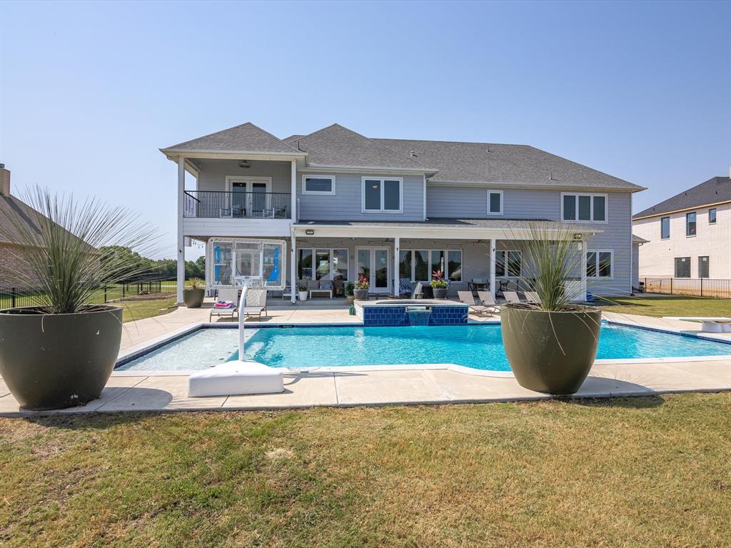 Eagle Mountain Lake LAKESIDE PARADISE complete with DOCK, POOL, & OUTDOOR KITCHEN! Enjoy year round Lake Life that feels miles away, but just 25 minutes to Fort Worth & TCU! Incredible views & waterfront breeze you’ve dreamed of! Designed to entertain, this CUSTOM HOME features a resort style diving pool & spa, new DOCK w LIFT, HUGE CHEFS KITCHEN w custom cabinetry, granite island, lg walk-in pantry & adjoining wet bar. Open concept layout w lower floor including 2 living spaces w 2 fireplaces, kitchen, dining & pane-glass workout or flex room plus 2 rooms used as office & guestroom or Mother-in-law suite! Upstairs boasts 2 en-suite bedrooms, a huge primary suite w spacious bathroom w double shower, soaking tub, walk-in closet & balcony, plus a Great Room Suite incl. bonus room & lg storage closet! Almost 1 acre in gated community w adjoining green-space to see tons of deer & beautiful views! Oversized 3-car garage for a large truck (1400 sqft), foam insulation means energy efficient!
