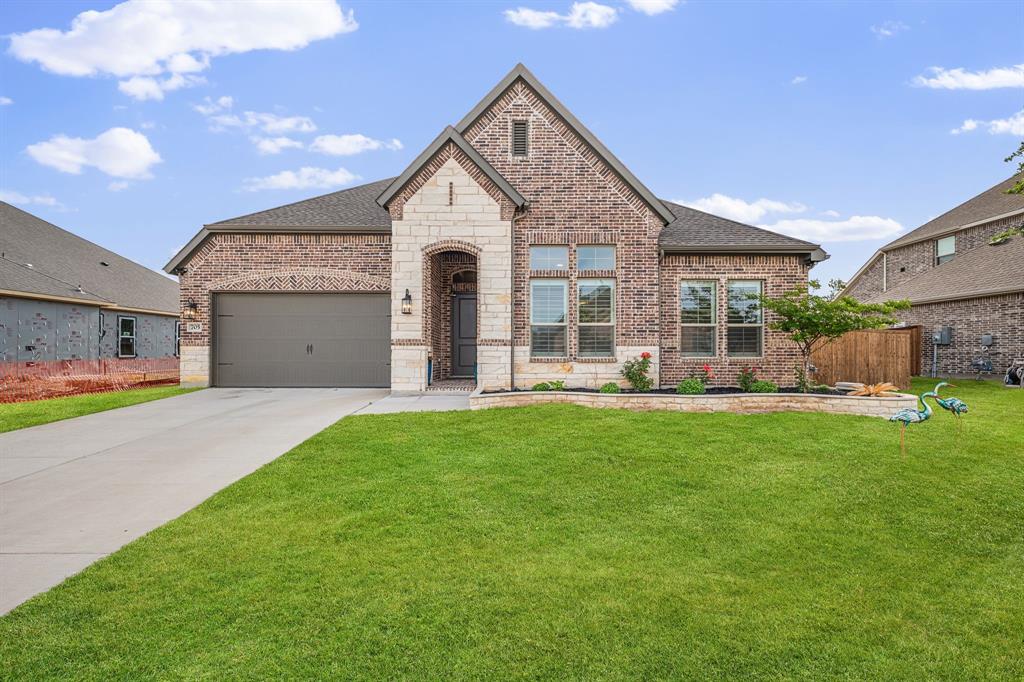 Completed in 2024 and ready for immediate move in, this beautifully upgraded 4 bedroom residence at 705 Allison offers a rare blend of modern design, thoughtful enhancements, and effortless indoor-outdoor living in the growing community of Van Alstyne. Inside, the home features today’s most desirable finishes , complemented by custom poly shutters and a sophisticated smart home system with integrated lighting, security, voice control, and whole-home connectivity. The open concept main living area features vaulted ceilings with wood beams, fireplace, light oak LVP flooring, and a double sliding glass patio door that truly elevates the space. The luxury kitchen is equipped with white shaker style cabinets against quartz countertops, floating wood shelving, designer lighting and a large center island that is perfect for entertaining.  The private owner’s suite is a true retreat, highlighted by soaring ceilings and designer dual-rail drapery that combines soft natural light with full blackout functionality—delivering both comfortable space that feels grand yet serene, and a primary bath with dual sinks, oversized shower and large walk in closet.  Additional interior features include a true flexibility in the floor plan with the 4th bedroom and 2nd living area having separate access from the front porch if desired to create fully dedicated guest suite, and a pocket office with barn door entry that provides that rare dual office setup that is perfect for the work from home lifestyle. Step outside to a backyard featuring a generous porcelain paver patio finished in large-format Ocean Palms tiles for an extended outdoor living area, while the screened enclosure offers year-round usability.  With over $30,000 in post-construction enhancements, this like-new home offers a level of finish and functionality that far exceeds typical new builds—making it a standout opportunity for buyers seeking modern luxury, convenience, and move-in-ready perfection.