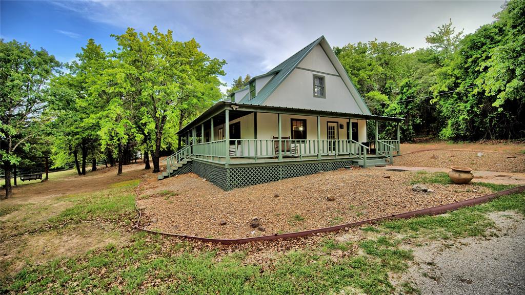 If you’re searching for a private retreat on acreage, this 4-bedroom, 2.5-bath home on 5 acres offers the perfect blend of comfort, charm, and seclusion. Located just north of Saint Jo and Muenster in the scenic North Texas Hill Country, the property sits in one of the area’s most desirable locations—less than half a mile from Blue Ostrich Winery.

The inviting country-style home features a layout filled with natural light, interior window shutters, and a warm, welcoming feel throughout. Recent updates—including a new roof, fresh interior paint, and a 2-year-old air conditioning system—provide added peace of mind for buyers.

A standout feature of the home is the expansive wraparound porch spanning three sides, offering the ideal space to relax, entertain, and take in the peaceful surroundings. Whether enjoying your morning coffee or unwinding in the evening, this outdoor space is designed for everyday living.

The land offers a beautiful mix of scattered trees for privacy and open areas for flexibility. Explore the trails, gather around the firepit under the stars, or make use of the barn for hobbies, storage, or livestock. Additional improvements include outdoor solar lighting and an updated well house and well pump. There is also a water filtration system including a reverse osmosis system.

With room to expand and endless possibilities, this property is perfect as a full-time residence or a private country getaway. Experience the quiet beauty and relaxed lifestyle that North Texas Hill Country living has to offer.