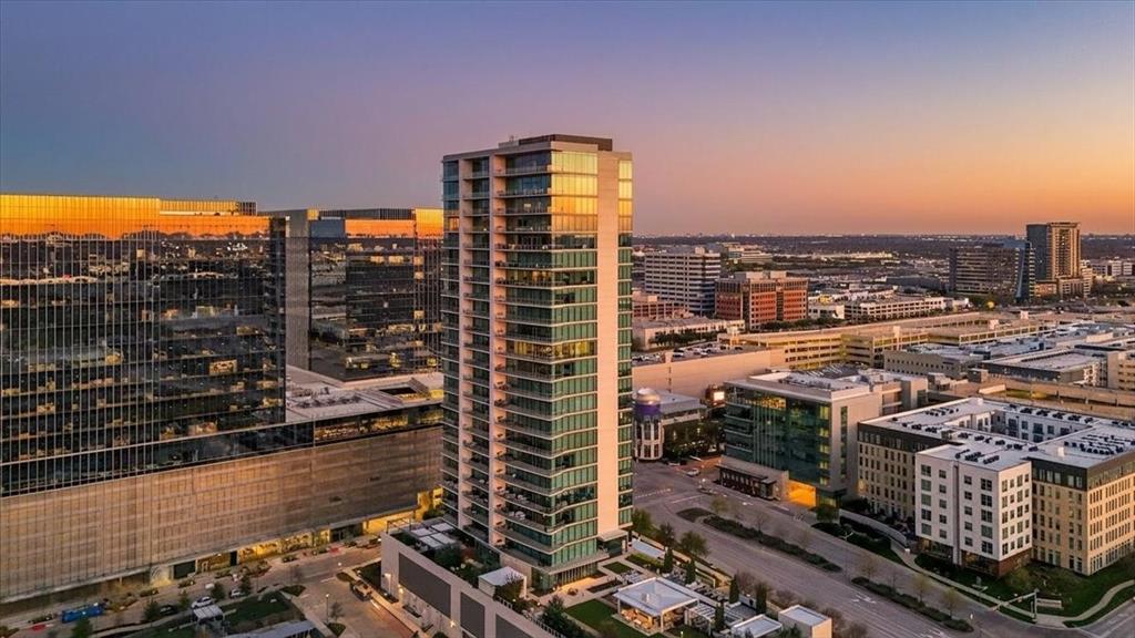 Windrose Tower is one of North Texas's most sought after communities. Situated high on the 17th floor, Residence 1701 showcases one of the building’s most desirable vantage points with dramatic floor to ceiling windows framing breathtaking skyline and sunset views. Designed for entertaining and everyday comfort, the open concept floor plan seamlessly connects the living, dining, kitchen, and custom bar areas. The chef’s kitchen features a striking quartzite waterfall island, custom cabinetry, Wolf and Sub Zero appliances, and a natural gas range- all positioned to capture the incredible views. The living area extends to a private balcony with a gas fireplace, perfect for enjoying morning coffee, golden hour sunsets, or city lights at night. The primary suite offers a peaceful retreat with a spa inspired bath featuring a soaking tub, oversized walk in shower, dual vanities, and a spacious custom closet. The secondary bedroom includes a private en suite bath with walk in shower and generous closet space. Designer finishes, hardwood floors, soaring ceilings, curated lighting, motorized shades, and smart home integration elevate every detail. Thoughtful upgrades throughout make Residence 1701 stand apart from other units. The home also includes two reserved garage parking spaces and a private storage unit. Residents enjoy premier amenities including concierge services, valet parking, a resort style saltwater pool with cabanas, state of the art fitness center, golf simulator, conference rooms, two lounge areas for large gatherings, outdoor kitchens, landscaped terraces, pet spa, and two guest suites. Located steps from the shopping, dining, and entertainment of Legacy West with convenient access to major highways and close proximity to both DFW International Airport and Love Field. Windrose Tower isn’t just keeping pace with luxury living, it is leading the way. Residence 1701 and its distinctive features place you at the center of an effortless lock and leave lifestyle.