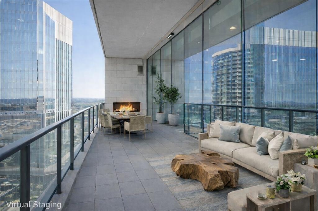 Windrose Tower is one of North Texas's most sought after communities. Situated high on the 17th floor, Residence 1701 showcases one of the building’s most desirable vantage points with dramatic floor to ceiling windows framing breathtaking skyline and sunset views. Designed for entertaining and everyday comfort, the open concept floor plan seamlessly connects the living, dining, kitchen, and custom bar areas. The chef’s kitchen features a striking quartzite waterfall island, custom cabinetry, Wolf and Sub Zero appliances, and a natural gas range- all positioned to capture the incredible views. The living area extends to a private balcony with a gas fireplace, perfect for enjoying morning coffee, golden hour sunsets, or city lights at night. The primary suite offers a peaceful retreat with a spa inspired bath featuring a soaking tub, oversized walk in shower, dual vanities, and a spacious custom closet. The secondary bedroom includes a private en suite bath with walk in shower and generous closet space. Designer finishes, hardwood floors, soaring ceilings, curated lighting, motorized shades, and smart home integration elevate every detail. Thoughtful upgrades throughout make Residence 1701 stand apart from other units. The home also includes two reserved garage parking spaces and a private storage unit. Residents enjoy premier amenities including concierge services, valet parking, a resort style saltwater pool with cabanas, state of the art fitness center, golf simulator, conference rooms, two lounge areas for large gatherings, outdoor kitchens, landscaped terraces, pet spa, and two guest suites. Located steps from the shopping, dining, and entertainment of Legacy West with convenient access to major highways and close proximity to both DFW International Airport and Love Field. Windrose Tower isn’t just keeping pace with luxury living, it is leading the way. Residence 1701 and its distinctive features place you at the center of an effortless lock and leave lifestyle.