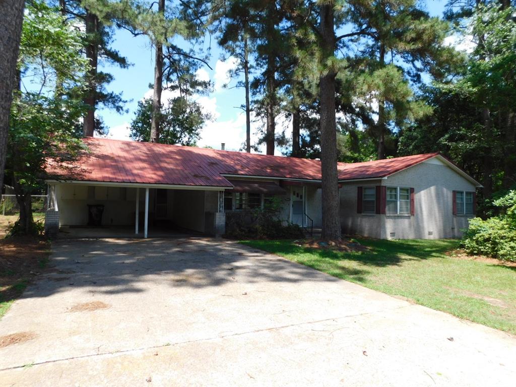 BRING YOUR DUCKS OR CATFISH TO SWIM IN THE PRIVATE POND WITH AERATOR IN THE BACKYARD OF THIS COUNTRY HOME! THIS 3 BEDROOM 2 BATHROOM HOME WITH APPROXIMATELY 1,885 SQUARE FEET OF LIVING AREA SITS ON A 1.19 ACRE COUNTRY LOT. HOME FEAURES A LOT OF PANELING, HARD WOOD FLOORS, A WOOD BURNING HEATER STOVE AND A WONDERFUL SUN PORCH THAT FACES THE FENCED IN BACKYARD. HOME ALSO  CENTRAL HEAT & AIR, A DOUBLE CARPORT AND RED METAL ROOF.