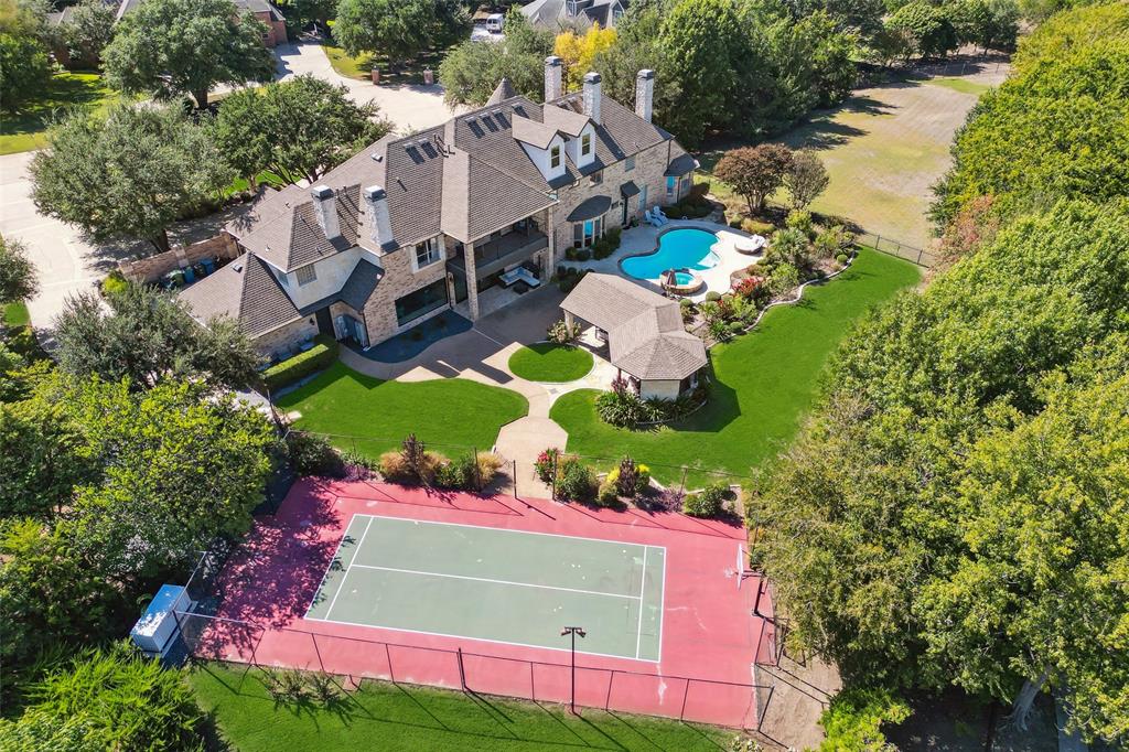 Incredible home on over 1.5 acres in desirable Oakwood Estates and Lovejoy ISD! Stunning property boasts tennis,basketball court and incredible outdoor living with pool, cabana, outdoor kitchen and still tons of backyard space for every desire. Magnificent 2-story entry, notable custom lighting throughout, upgraded padding & carpet, newly added large windows and slider doors. Completely remodeled kitchen by a true chef, not just aesthetic with brass and glass open shelving, self-close drawers and cabinets and leathered marble and granite c-tops, but also featuring the most desirable and functional chef's appliances. Designer butler's pantry and separate wet bar niche with window to serve outdoor guests! 3 master bedrooms with fireplaces, one downstairs bedroom converted into incredible closet with built-ins, upstairs gym with sauna & mirrored wall, game room plus 3rd story media room with wet bar. Coveted location on a cul-de-sac, whole house generator & almost 1m in recent upgrades!