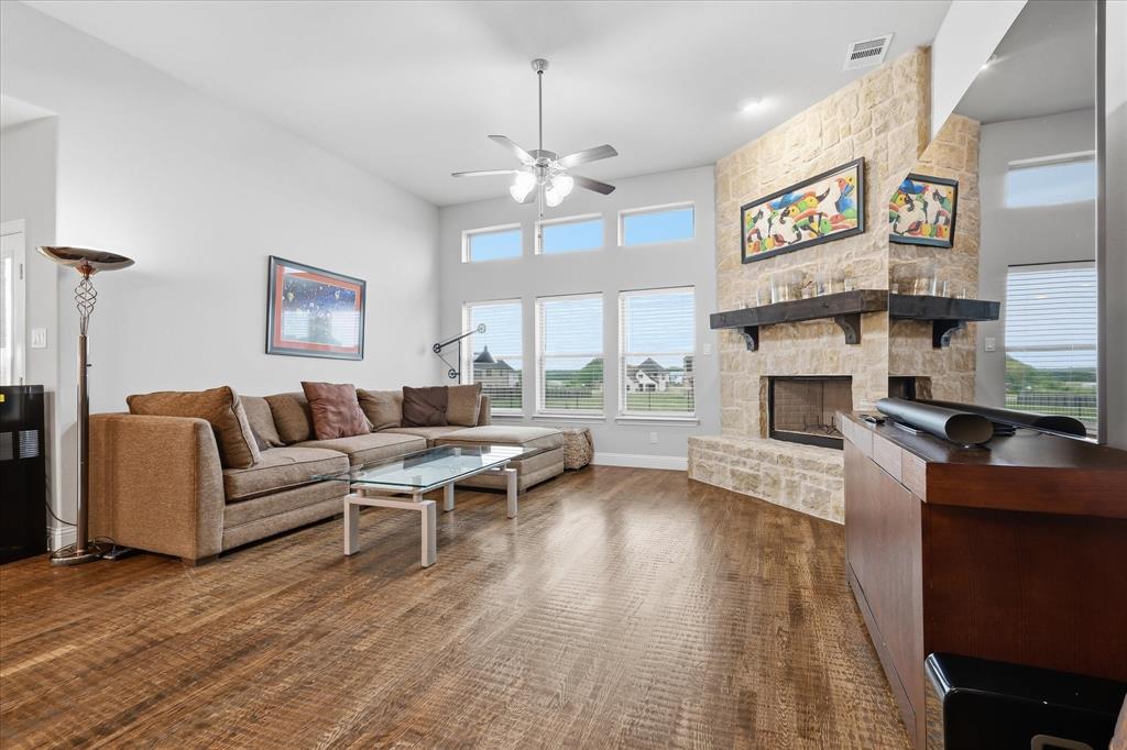 The complete lifestyle package everyone has been looking for. Almost 3700 square feet of custom builder designs on a full one acre lot creates the kind of home families search for. Spacious, refined, and built for everyday function, this home offers room to grow, entertain, and enjoy life without sacrificing comfort or style. The foyer opens to soaring ceilings, hand scraped hardwood floors, and expansive sightlines that immediately showcase the scale of the home. Natural light fills the main living areas, creating an atmosphere that feels bright, and connected. The main living room is anchored by a striking Austin stone fireplace that adds warmth and character while serving as the centerpiece of the home. The kitchen delivers both beauty and utility with an oversized granite island, farmhouse sink, abundant cabinetry, and generous prep space. Whether hosting guests, serving holidays, or handling busy weekday routines, this kitchen was designed to perform while keeping everyone connected. Spacious bedrooms throughout the home provide comfort, privacy, and flexibility for a growing family. Each room offers the space needed for larger furniture, study areas, or personal retreats.Upstairs, the extra large media room creates the perfect setting for movies, sports, and gaming. A separate game room adds even more options for recreation, work, fitness, or hobbies. The most valuable features is the true 6 car garage and new epoxy floors. Ideal for multiple vehicles, storage, recreational equipment, a workshop, or future projects, it offers space that is increasingly hard to find. Outside, the one acre lot provides the freedom to create your own outdoor lifestyle. Add a pool, outdoor kitchen, garden, play area, guest shop, or simply enjoy the open space and privacy that come with larger land ownership. This home combines size, land, and functionality in a way that stands out from typical offerings. For buyers wanting space, quality, and a long term lifestyle