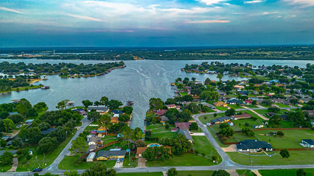Welcome to 3713 Indian Creek Trail—an exceptional lakeside retreat in Granbury, Texas. This beautifully maintained single-story home blends modern comfort with resort-style amenities, offering the perfect balance of relaxation, privacy, and convenience near Lake Granbury.

As you enter, you're welcomed into a spacious, light-filled interior where soaring ceilings and expansive windows create a bright, airy atmosphere. The open-concept living room flows into a thoughtfully designed kitchen featuring sleek countertops, stainless appliances, and generous cabinetry—ideal for casual dining or hosting family and friends.

The home offers multiple well-sized bedrooms and beautifully appointed bathrooms, including a luxurious primary suite that feels like a private retreat. Unwind in your own personal wellness spa, complete with a custom sauna and a separate steam room—rare finds that elevate the home’s comfort and relaxation to a whole new level. Storage is no issue thanks to an oversized cedar closet, perfect for keeping your wardrobe fresh and organized year-round.

Step outside into your private backyard paradise. A sparkling in-ground pool invites refreshing dips on warm Texas days, while the surrounding patio and lush landscaping set the stage for entertaining or peaceful lounging. Enjoy access from your backyard into Lake Granbury, perfect for kayaking, fishing, or simply soaking in the scenic beauty of Lake Granbury.

Tucked away in a quiet, gated neighborhood, yet minutes from Granbury’s historic town square, top-rated schools, shopping, and dining, this home truly has it all. Whether you’re seeking a full-time residence or a weekend escape, 3713 Indian Creek Trail delivers a lifestyle of comfort and lakeside charm.

Don’t miss this rare opportunity—schedule your private tour today and experience the very best of Granbury living.