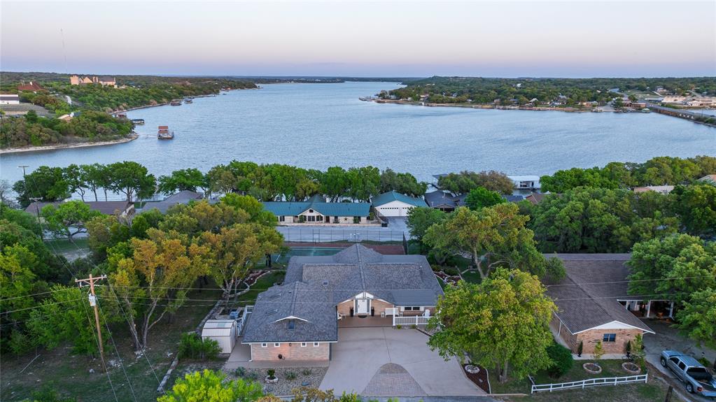 Welcome to your private retreat overlooking beautiful Lake Brownwood! This stunning 5-bedroom, 2 full bath, 2 half bath home offers the perfect blend of space, functionality, and breathtaking views.

Designed for both comfort and entertaining, the main level features a bright and open living area with large windows that capture incredible lake views, along with a well-appointed kitchen, utility room, and a spacious primary suite with ensuite bath. An additional bedroom and bathroom are also conveniently located on the main level.

The lower level offers even more living space, including a second large living area, additional bedrooms, and baths—perfect for guests, family, or multi-generational living. With two expansive living rooms (one on each level), there’s plenty of room to relax or host gatherings.

Step outside to enjoy the huge deck, ideal for taking in the peaceful surroundings and scenic lake views. Situated in a secluded neighborhood, this property provides privacy while still offering access to a nearby boat ramp, making lake days easy and convenient.