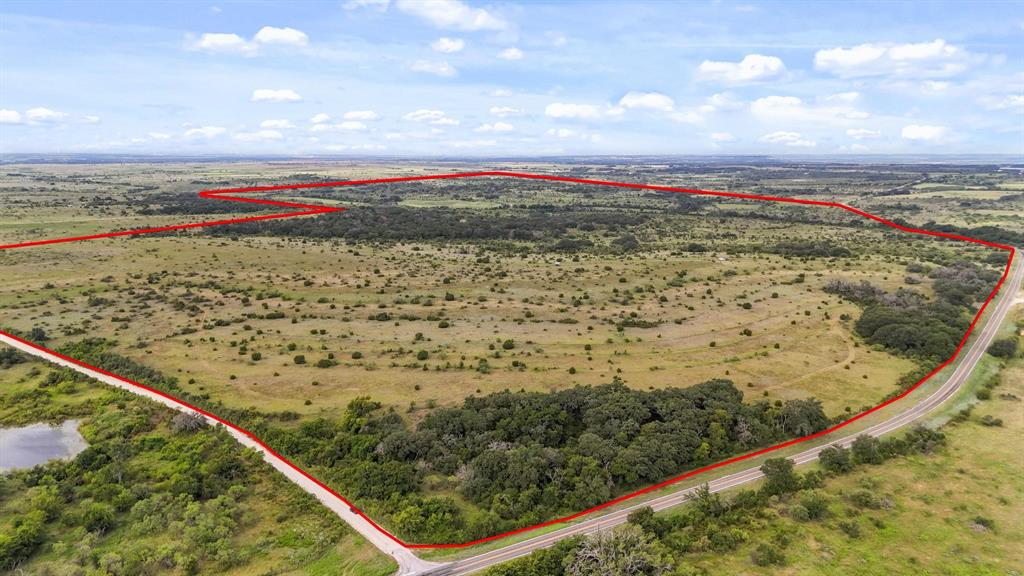 Beautiful 522+- acres with Warren Creek winding through. The native landscape offers great elevation changes providing views that you can see for miles and the possibility of several awesome building sites. There are beautiful live oaks, post oaks, and other hardwood trees adding to the privacy of the ranch and protection for the wildlife and livestock. Another amenity to this picturesque ranch is a watering tank for all animals and recreational fishing. The blank canvas of natural beauty allows for someone to build their own masterpiece. The possibilities are endless with this ranch......your forever home, hunting ranch, recreational ranch, great high fence potential, or combination of them all. The road frontage on two sides, with one being paved, allows great access. Come take a tour of the property and become an owner of a beautiful piece of Texas.  Will divide.