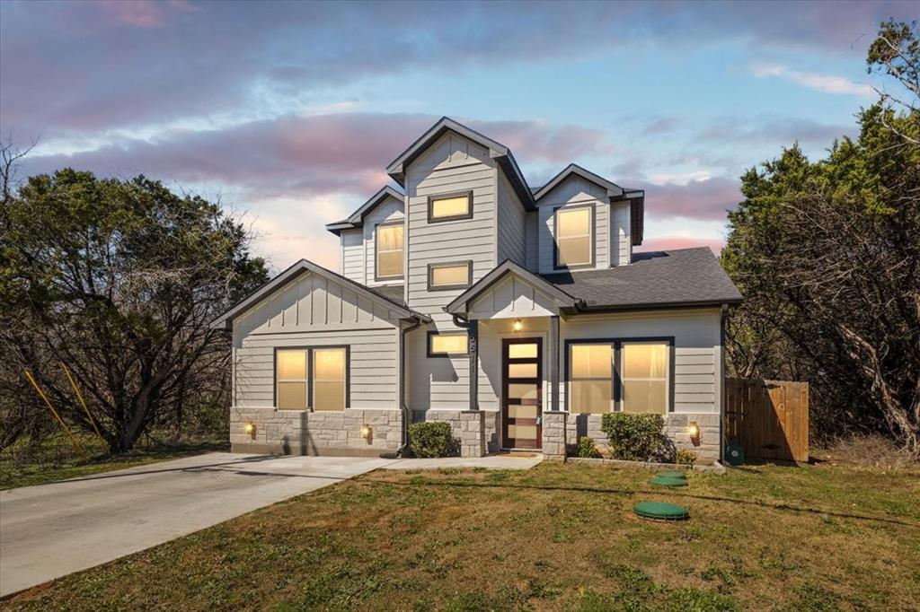 Gated Community. Great Curb Appeal with stone accents and multi level Elevation. Be welcomed home by all the modern conveniences and designer choices in color and materials. Five panel glass front door allows natural light and is beautiful. Oak Color LVP throughout the first level of this ideal Open Concept 3BR, 2.5 Bath home. High ceilings contribute to the spacious feel of the Living, Dining, Kitchen area. Kitchen is sure to please if you cook or bake a lot. The island provides even more prep space, triple pendants for lighting & additional seating to join in on cook-time conversations. Shaker style cabinets and a walk in pantry offer plenty of storage. Sleek Stainless Steel appliances and a window by the sink are just a few more added touches that you can enjoy. The Primary Bedroom is downstairs and can accomodate a Texas Sized King Bed and furniture. The ensuite Primary Bathroom has Dual sinks, seamless glass shower, and a large Walk in Closet. Laundry and a Half Bath for guests are also downstairs. Upstairs you will find 2 spacious secondary bedrooms separated by a Jack-N-Jill Bathroom. Private fenced in backyard and covered back patio. Enjoy resort-style community amenities including parks, pools, and basketball courts, and with its prime location just minutes from Lake Granbury, shopping, and dining. Do not miss Vitual Tour.