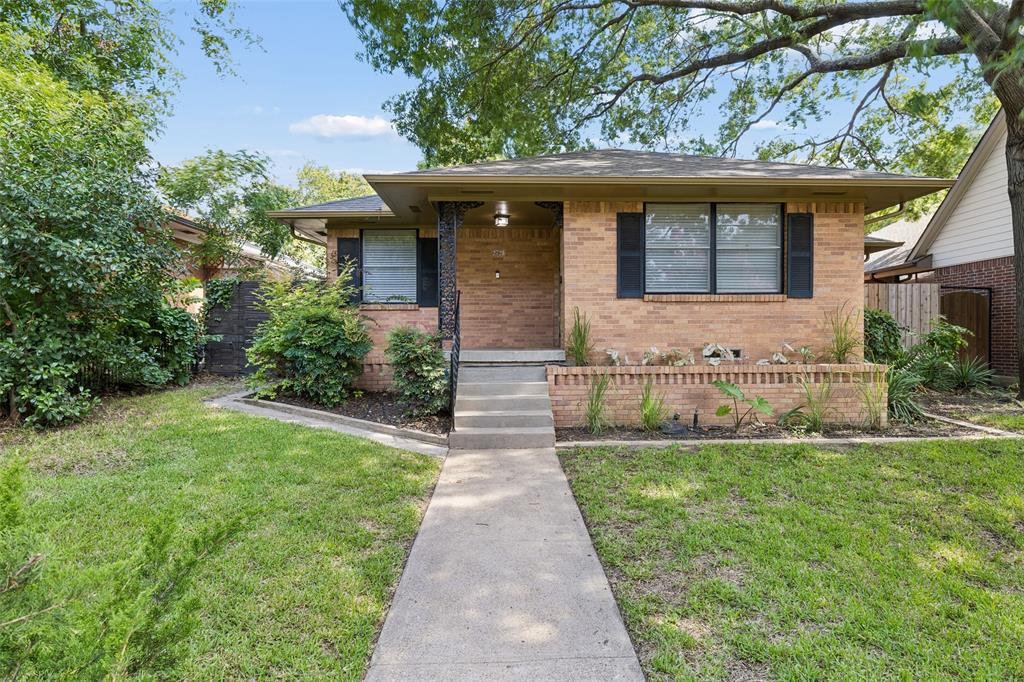 Perched on an elevated lot, this updated ranch boasts incredible curb appeal with majestic shade trees, intricate brick retaining walls, and planter beds ready for your green thumb. Nestled in the heart of highly desired Kessler Plaza, this Mid-Century Ranch has plenty of modern flair. Step inside to gleaming hardwood floors and freshly painted art walls that feel straight out of a gallery. The eat-in kitchen shines with a cozy breakfast nook and a massive walk-in pantry for all your culinary adventures. The enclosed breezeway, complete with exposed brick wall and abundant natural light, doubles as a laundry space and home office. The main house offers 3 spacious bedrooms and 2 full baths, while the detached finished studio adds flexibility—think detached office, gym or creative space. The freshly stained deck overlooking the expansive backyard allows for easy entertaining our pop over to Bishop Arts just minutes away. This trendy Oak Cliff gem delivers style, space, and location all in one!