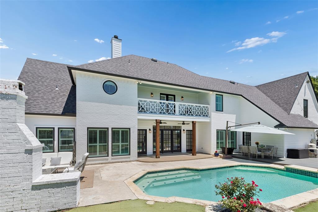 Southfork Ranch-inspired curb appeal in the heart of Rockwall–Heath. Set on an impressive 1.18-acre homesite in a sought-after lakeside community, this beautifully designed estate offers timeless Texas charm less than an hour from Dallas.
From the moment you arrive, the commanding presence and manicured grounds create a sense of arrival unlike anything else nearby. Inside, a welcoming foyer showcases a graceful curved staircase and a wall of back windows that draw your eye straight to the private pool, spa, and outdoor living spaces beyond.

Designed for both relaxed living and effortless entertaining, the home offers multiple gathering spaces including a formal living area, inviting den, and expansive outdoor lounge space centered around a cozy fireplace. The light-filled kitchen is ideal for preparing meals to enjoy casually in the breakfast nook, elegantly in the formal dining room with fireplace, or al fresco beneath the Texas sky on the outdoor deck.

A downstairs study offers flexibility. Upstairs, the owner’s retreat feels like a private sanctuary with its own fireplace, dressing area with makeup vanity, bidet, and sun-drenched garden tub bath designed for unwinding at the end of the day.

Three additional bedrooms and an upstairs game room provide plenty of space for movie and game nights. Step outside to catch breathtaking sunset views from the upper deck.

Just minutes away, enjoy the best of lakeside living with boating, fishing, skiing, and waterfront relaxation nearby. With room for a boat trailer and expansive grassy areas for play, this property captures the spirit of luxury Texas living with space to breathe, entertain, and make lasting memories.