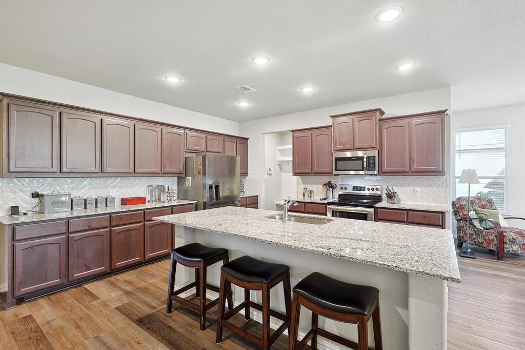 Welcome to 808 Feather Edge Drive in Springtown, Texas, where thoughtful design, modern finishes, and comfortable living come together in one exceptional home. This beautifully maintained 3-bedroom, 2-bath residence features an open-concept floor plan designed for both everyday living and entertaining.

At the center of the home, the spacious kitchen offers a large island with seating, abundant counter space, granite countertops, and a generous walk-in pantry, creating the perfect space for meal preparation, gatherings, and daily convenience. The kitchen flows seamlessly into the living and dining areas, enhancing the home's bright and inviting atmosphere.

The private primary suite provides a relaxing retreat with a spacious bedroom, luxurious ensuite bath featuring a soaking tub, separate shower, and an oversized walk-in closet. Two additional bedrooms and a well-appointed full bath offer flexibility for guests, home office space, or additional living needs.

Additional features include crown molding, a convenient mudroom bench, ample storage, and quality finishes throughout. Conveniently located in Springtown with easy access to local shopping, dining, schools, and commuting routes, this move-in-ready home offers the perfect combination of style, comfort, and functionality.
