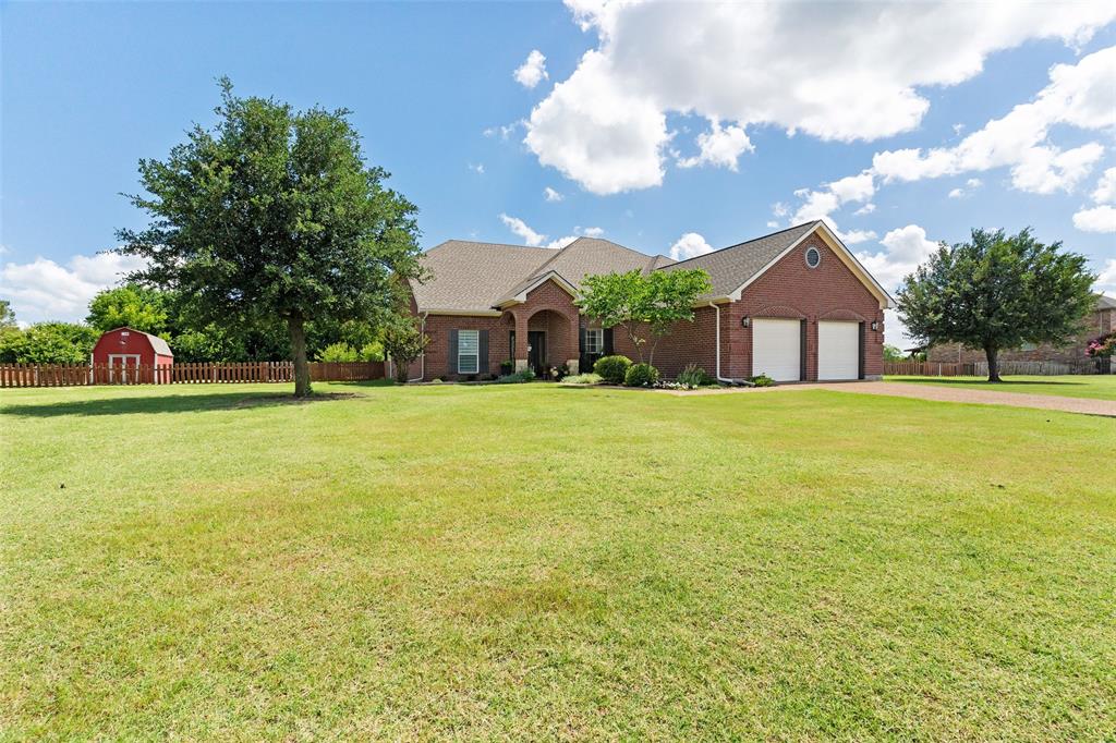 Escape to the perfect blend of privacy, space, and convenience on 1.55 beautiful acres with NO HOA! Surrounded by mature trees and a tree-lined rear property line, this exceptional property offers the peaceful setting you've been searching for while remaining just minutes from shopping, dining, Lake Lavon, and SH 78. Designed for both everyday living and entertaining, the open-concept floorplan centers around a spacious Living Room featuring a cozy fireplace and a wall of windows overlooking the backyard retreat. The Kitchen is well-appointed with stainless steel appliances, abundant cabinetry, generous counter space, a center island, walk-in pantry, and sunny Breakfast Nook with picturesque backyard views. The private Primary Suite provides a true escape, complete with a spa-like bath featuring dual vanities, a walk-in shower, jetted tub, and an impressive custom closet. Downstairs also offers a dedicated Study w french doors, Formal Dining Room, and convenient Powder Bath. Upstairs, you'll find three generously-sized secondary bedrooms AND an oversized Game Room with built-ins, creating endless possibilities for a media room, playroom, or flex space tailored to your needs. Step outside and experience your own backyard OASIS! The sparkling heated pool and spa are separately fenced for added safety and peace of mind, while the expansive Covered Patio provides the perfect setting for outdoor dining, entertaining, or simply relaxing while enjoying the serene surroundings. A 12x16 storage building-workshop offers additional space for hobbies, tools, equipment, or extra storage. With mature trees, incredible outdoor living spaces, NO HOA restrictions, and highly sought-after Wylie ISD, this property delivers the rare combination of acreage living, functionality, and convenience.