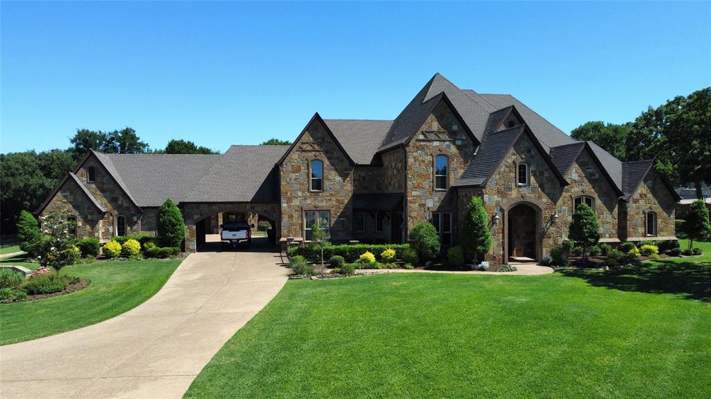 Immaculate 4-Bed, 4-Bath Estate on 1.89 Acres with Game Room & Guest Quarters! Experience luxury living in this beautifully updated estate set on nearly 2 acres. The home features a grand entrance, soaring cathedral ceilings, and designer finishes throughout. The gourmet kitchen includes a large island, breakfast bar, custom cabinetry, marble flooring, double ovens, and a built-in refrigerator-freezer. The primary suite offers marble countertops, dual vanities, jetted tub, fireplace, towel warmer, and a large shower. The main level also features two additional bedrooms, two full baths, a private office, and a spacious laundry room. Upstairs includes a large game room, fourth bedroom, full bath, and space for a potential sixth bedroom and bath. With additional bedroom & full bath, the separate guest quarters offer a private retreat for visitors. Recent upgrades include new paint, carpet, lighting, and hardware. Energy-efficient and move-in ready! A Lane Garrett Custom Home.