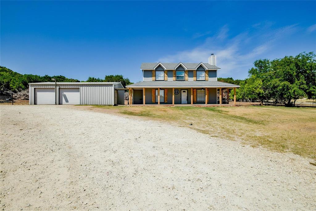MOTIVATED SELLER! Bring us an offer...... don't miss out on this smokin' deal! Come on out to the countryside retreat with commanding views of Comanche Peak — this impressive two-story home on just over 2 acres offers privacy, space and endless possibilities. Thoughtfully sited beneath an inviting canopy of mature trees, the property welcomes you down a scenic driveway to a residence designed for entertaining and everyday comfort. The huge kitchen is built for gatherings and entertaining, flowing to comfortable living spaces and outdoor views. A 600 sq. ft. addition offers versatile square footage ideal for a home business, craft studio, gym or guest suite — configure it to suit your lifestyle. Outside, a substantial 30' x 40' shop with two drive-through bays, 200-amp service and both heating and air conditioning is a craftsman’s dream or perfect for RV or boat storage and projects. All of this in close proximity to historic downtown Granbury and the recreational opportunities of Lake Granbury — enjoy country living with convenient access to town. Don’t miss this special property with panoramic hill country views and room to grow.