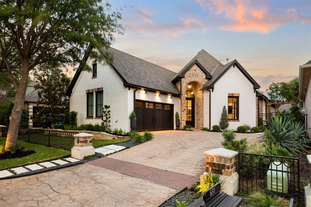 Within Timarron's Crescent Royale, fully remodeled villas of this caliber rarely become available. Mature trees frame the approach, leading to a stone arched entry and an exterior that immediately hints at what awaits inside. White painted brick and curated landscaping give the home a fresh, refined presence while preserving the architectural character that makes Timarron so desirable. Inside, soaring ceilings and wide plank floors set the stage, but it is the attention to detail that defines the experience. The dining room immediately captures your attention with a dramatic mural, statement lighting, and a contrasting ceiling treatment that gives the space its own identity. Nearby, floor to ceiling windows fill the living room with courtyard light, while a porcelain fireplace anchors the room with warmth and sophistication. At the center of the home, the kitchen was designed to be both functional and beautiful. An oversized island anchors the space, surrounded by custom cabinetry, professional grade appliances, and a built in wine display seamlessly integrated into the design. Just beyond, the family room creates a comfortable gathering space and opens effortlessly to the outdoor living areas. Privately positioned away from the main living spaces, the owner's suite offers a quiet retreat at the end of the day. The spa inspired bath features a freestanding soaking tub, oversized steam shower, floating dual vanity, and designer finishes throughout. Outside, the backyard was designed for relaxed evenings and effortless entertaining. A pool, outdoor kitchen, and custom privacy fencing create a secluded setting that feels private and inviting. With HOA maintained front yard care, this is true lock and leave living in the heart of Southlake. Just moments from Timarron Country Club, the golf course, and within Carroll ISD, this home offers a rare combination of design, exceptional location, and the ease of a lifestyle that lets you simply lock the door and go.