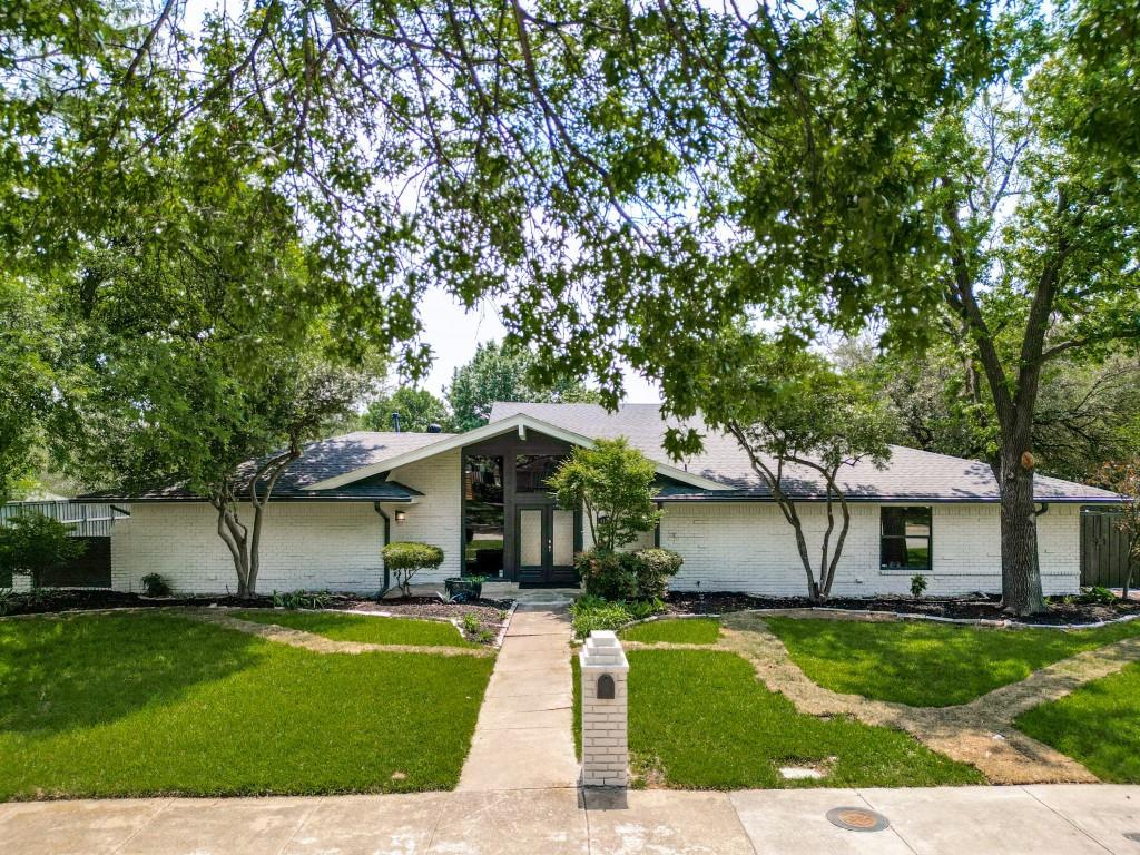 Unbeatable location! This Distinctive midcentury modern ranch delivers standout architecture, incredible curb appeal, and an entertainer’s dream layout on a stunning oversized interior corner lot. Major system upgrades already completed including roof, BOTH HVAC systems, electrical, and plumbing. No cast iron plumbing — ALL new PVC plumbing installed in 2026 beneath the home and extended to the street. Thoughtfully designed with 2 split-level great rooms, the open-concept floorplan offers exceptional flexibility for everyday living, relaxing, or hosting guests. Engineered hardwoods, new plush carpet, 4000K LED lighting, fresh neutral interior+exterior paint selections, kitchen with stainless steel appliances, granite countertops, oversized island, and shaker-style cabinetry. The private primary retreat features an oversized walk-in shower and large walk-in closet for a true spa-like feel.  Enjoy the peaceful outdoor setting with a private balcony, flagstone patio, courtyard, and board-on-board fencing. 4th bedroom could easily double as private office if desired. Oversized rear-entry garage with epoxy floor offers bonus parking+storage & has updated garage doors, motors, and openers. Ultra convenient location near DNT, 635, 75. ENJOY being in close proximity to multiple country clubs, top private schools, dining+nightlife, parks, and trail systems. Pride of ownership is evident here. Opportunities to own a home like this are rare—don’t miss your chance to make it yours!
