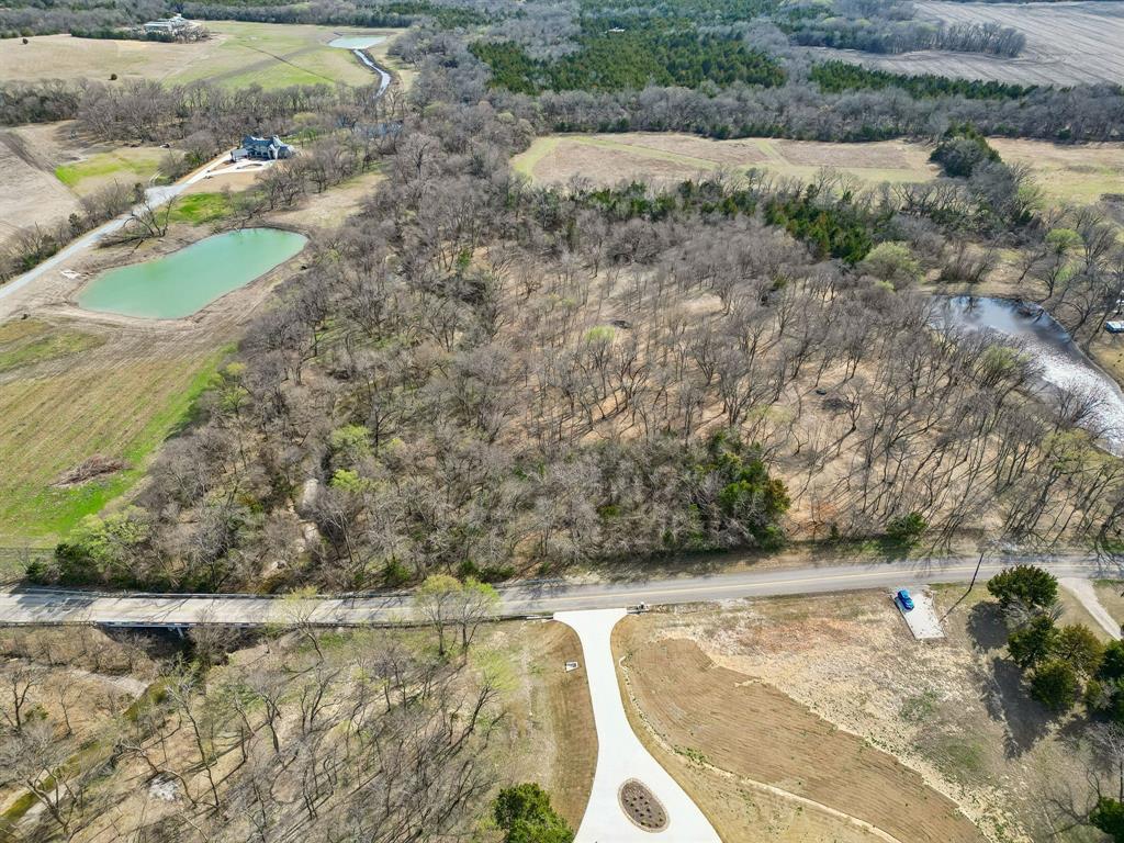 Discover the perfect blend of privacy, natural beauty, and opportunity on this stunning 12.64-acre property. Nestled among an abundance of mature trees, this peaceful retreat offers a serene setting where nature takes center stage. A gently flowing creek winds down one side of the property, adding both charm and tranquility while attracting local wildlife and enhancing the land’s natural character.

With plenty of space to build your dream home, create a private getaway, or invest in land for the future, this property offers endless possibilities, only 25 minutes from McKinney. The lush tree cover provides natural shade, privacy, and picturesque views in every direction, making it an ideal setting for those seeking quiet country living away from the noise and congestion of the city while still being close enough to access all that city life has to offer.

Whether you're looking for a peaceful homesite, recreational escape, or long-term investment, this beautiful 12.64-acre tract delivers the rare combination of privacy, natural scenery, and room to grow. It is currently zoned agricultural with an ag exemption and is outside of city limits! Yay tax savings! It also already has a water meter and hose hydrant on the property and electricity can be brought to the property easily through the Grayson County Electrical Co-op. Experience the calm of nature, the sound of the creek, and the freedom that only acreage like this can provide.