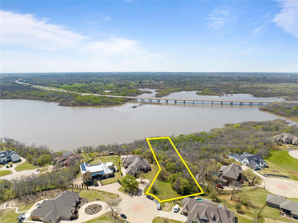 Discover the epitome of luxury living at The Bluffs at Pinnell Pointe. This picturesque 1.26-acre lot boasts breathtaking lakefront views, offering direct access to the tranquil waters of Lake Lewisville right from your own backyard.
Situated in a serene enclave, this idyllic community provides the perfect canvas to build your dream home. Enjoy the best of both worlds with city conveniences just minutes away from major highways and DFW Airport, while relishing the serenity of lakeside living.
For aquatic enthusiasts, The Bluffs at Pinnell Pointe is a true haven. Dive into a world of boating, fishing, and sailing adventures, all within arm's reach. Don't miss the opportunity to create your own sanctuary in this exclusive lakeside community.