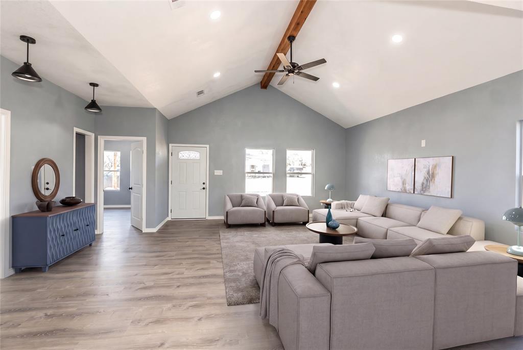 USDA-Eligible—Move-In Ready! Welcome home to this beautifully finished home featuring a spacious open-concept layout designed for everyday living and easy entertaining. Step into a light-filled living room with a vaulted ceiling, tasteful woodwork details, and a convenient built-in desk, perfect for working from home or managing household tasks. The kitchen is a standout with custom cabinetry, a large island with seating or extra storage, and brand-new stainless steel appliances ready for your favorite recipes. Both bathrooms continue the upscale feel with matching custom cabinetry and quality finishes. Unwind in the primary suite offering a tiled shower and a large walk-in closet. The two additional bedrooms are generously sized with ample closet space. Need storage? The oversized attic is ideal for seasonal items and features spray foam insulation for added efficiency. Enjoy the outdoors from two covered porches, and appreciate the practicality of a full utility room located just off the side entrance.