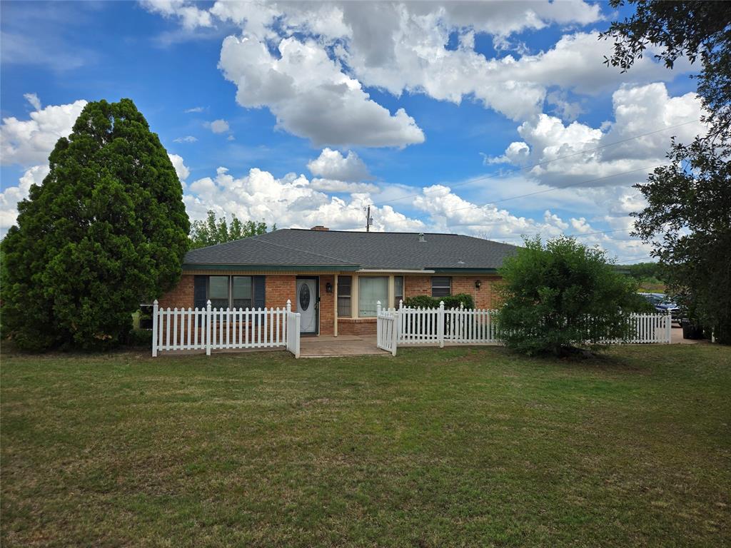 Country living without the commute! Located on over 10 acres this 2,255 sq ft. 3 bedroom, 2 bath, 2 living room homestead features a 2 car garage, barn, storage buildings, working water well, tank, huge utility pantry, fireplace with insert, and large covered deck for year round entertaining. Kitchen & flooring remodeled in 2025. Electric panel replaced 2025. Varied landscape great for recreation, raising animals, and hobby farming. Beautiful Live Oaks. Minutes from shopping and the highway loop, so you can quickly travel to all parts of town. On City water.