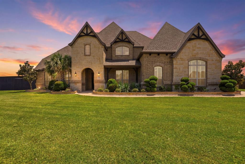 Custom luxury meets country living in the highly sought-after Midlothian ISD! Situated on a beautifully maintained 1.21-acre corner lot in Waxahachie, this stunning custom home, built in 2019, offers 3,096 square feet, 4 bedrooms, 3.5 bathrooms, and exceptional flexibility inside and out. The open-concept floor plan showcases rich wood flooring, soaring ceilings, a spacious living room with a fireplace, and a beautifully appointed kitchen featuring granite countertops, custom cabinetry, a large island, and abundant storage. All four bedrooms are conveniently located downstairs, including the private primary suite with a soaking tub, oversized walk-in shower, dual vanities, and a generous walk-in closet. A secondary bedroom with its own full bath provides the perfect setup for guests, multigenerational living, or a private mother-in-law suite. Upstairs is designed for entertaining with a dedicated media room, spacious second living area, and convenient half bath, creating the perfect retreat for movie nights, game days, or a playroom while keeping the bedroom level quiet and private. Outside, you’ll find room for all your hobbies and toys with an attached six-car garage, a separate lawn equipment garage, and an approximately 270-square-foot brick flex building just off the covered back patio, ideal for a home office, gym, workshop, or studio. The expansive, fully fenced backyard offers plenty of room to add your dream pool while still leaving ample space for entertaining, pets, or outdoor activities. With exceptional curb appeal, meticulous maintenance, versatile living spaces, and incredible garage and flex space, this one-of-a-kind property offers the perfect blend of luxury, functionality, and room to grow all within the desired Midlothian ISD.
This home is not eligible for an FHA contract until after 8-26-2026. Prior to 8-26-2026, only Conventional, Cash or possibly VA (depending on lender requirements) will be accepted.