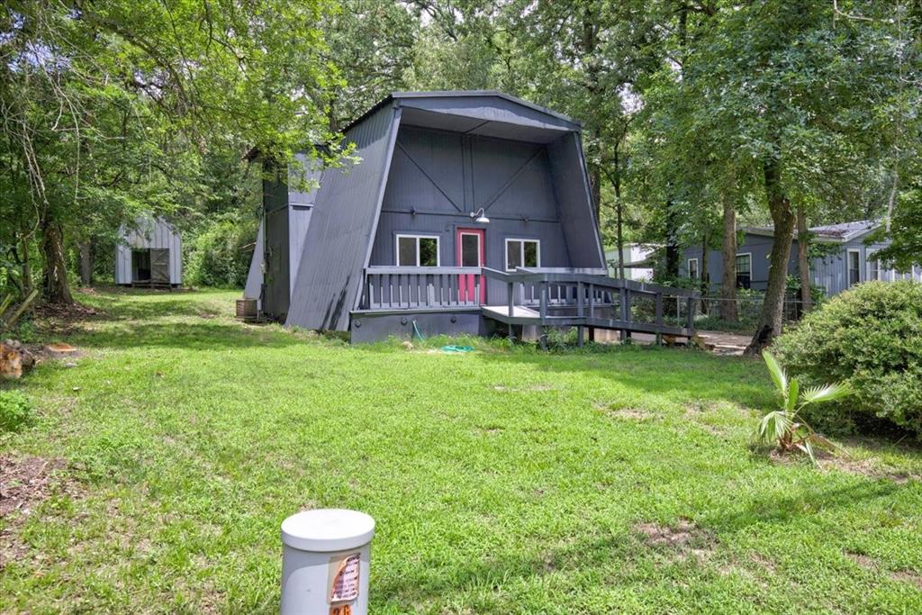 3 bedroom, 2 bath charmer nestled among the trees. Fresh paint and thoughtful updates create a warm and inviting atmosphere in this charming home. The main level features a spacious family room with hardwood flooring and a kitchen with durable linoleum flooring and a convenient pass-through bar for entertaining. Just beyond the kitchen, you'll find a versatile bonus room with the laundry area located nearby, offering additional space for a home office, hobby room, or playroom. The primary bedroom and full bath are located downstairs for added convenience. Upstairs two additional bedrooms and a bathroom with a shower provide comfortable accommodations for family or guests. Situated on a mostly wooded lot, the property offers a peaceful setting with both front and back yards gently sloping toward the road, creating a scenic backdrop and plenty of natural beauty to enjoy.