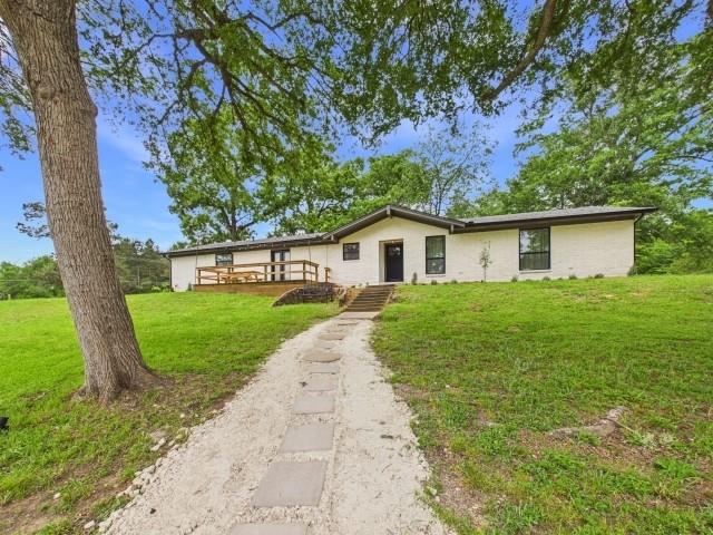 Set on a corner lot with over half an acre of elevated hilltop view, this 3 bedroom, 2 bathroom home offers approximately 2,200 square feet of thoughtfully updated living space and a layout that feels both open and inviting. The home has been taken down to the studs and rebuilt entirely, offering the feel of new construction while sitting on an established lot. Additional highlights include all new electrical, new roof, new foundation, flooring, fixtures, and updated electrical amenities that include remote-controlled ceiling fans installed in every room. The interior features a seamless flow between the living, kitchen, and dining areas, creating a comfortable space for everyday living and entertaining. The kitchen is finished with quartz countertops, brand new appliances, and modern updates throughout. The dining area includes double glass doors that lead out to the front porch deck, bringing in natural light and offering an easy connection to the outdoor space. The primary bedroom features a double-door walk-in closet, providing ample storage and functionality along with an updated ensuite bathroom with a large double-headed walk-in shower. Outside, the property includes a gravel circle driveway and an additional side driveway that leads to the 2-car garage with direct access into the mudroom, adding convenience and functionality. Located in Palestine, the home is just minutes from local shopping, dining, schools, and medical facilities, while still offering space, privacy, and a peaceful setting.