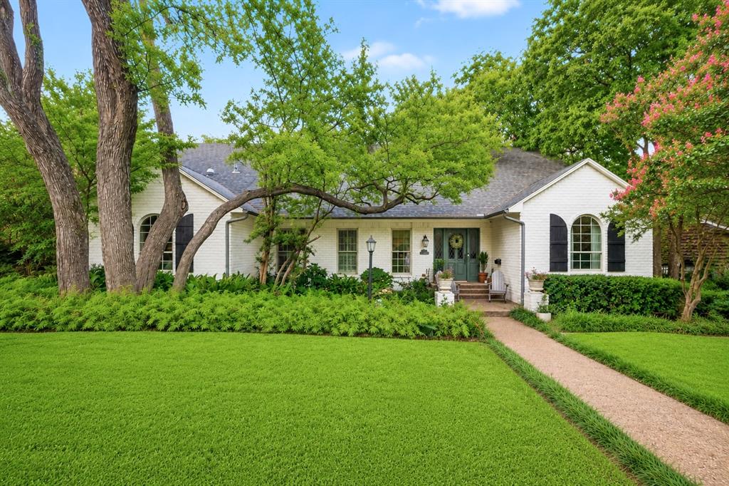 In the heart of Lake Highlands, this beautifully maintained two-story residence offers timeless architecture, exceptional craftsmanship, and inviting spaces designed for everyday living and memorable entertaining.
From the moment you arrive, the home's classic curb appeal sets the tone. Inside, rich architectural details and warm finishes feel both elegant and welcoming. The heart of the home is the spacious den, where 100-year-old reclaimed pine and fir flooring pairs beautifully with a stunning reclaimed brick fireplace, creating a one-of-a-kind gathering space full of character and history.
The thoughtfully designed floor plan features five bedrooms and four bathrooms, including one currently appointed as an office, offering flexibility for growing families or guests. A generous formal dining room sits just off the kitchen, making holiday celebrations and dinner parties effortless.
The kitchen offers abundant cabinetry, generous prep space, and a large center island, flowing seamlessly into the living spaces to encourage connection throughout the home.
The primary suite is a peaceful retreat, highlighted by a bath featuring white quartzite countertops. Luxurious Taj Mahal quartzite adds a designer touch to the powder bath and upstairs Jack and Jill bath.
Step outside to a backyard designed for year-round enjoyment. The fully turfed lawn creates a lush, low-maintenance oasis surrounded by mature trees that provide exceptional privacy and shade. A covered patio offers the perfect setting for morning coffee, outdoor dining, or relaxing evenings.
Additional highlights include a wide two-car garage, two HVAC systems for enhanced efficiency, generous storage, and the enduring charm of a home built with quality materials and thoughtful design.
Offering classic character, exceptional craftsmanship, and an unbeatable Lake Highlands location, this is a rare opportunity to own a home where timeless design meets modern comfort.