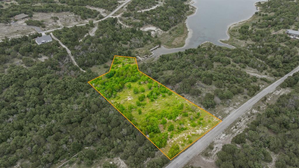 Rare opportunity to own two adjoining 1-acre tracts located on a peaceful inlet of Beacon Lake. Build your dream home on one lot and keep the second as a privacy buffer, sell it in the future, or re-plat and combine both parcels into a spacious 2-acre homesite. Whether you're looking for extra room, investment potential, or added privacy, this unique property offers options to fit your needs. Create your own private retreat while maintaining the opportunity for future value and flexibility. Conveniently located in the heart of the subdivision, with water and electricity available at the front of the lot. No build time requirement and a 1,400 sq. ft. minimum living space. Annual assessment is just 295. Located in Bluff Dale, Texas—perfectly situated on Hwy 377 between the Cowboy Capital of the World, Stephenville, and the historic town of Granbury. Come experience breathtaking Texas sunsets, star-filled skies, and abundant wildlife. Mountain Lakes amenities include a recreational lake, fishing lake, clubhouse, pool, park, walking path, garden, and RV park—country living at its finest!