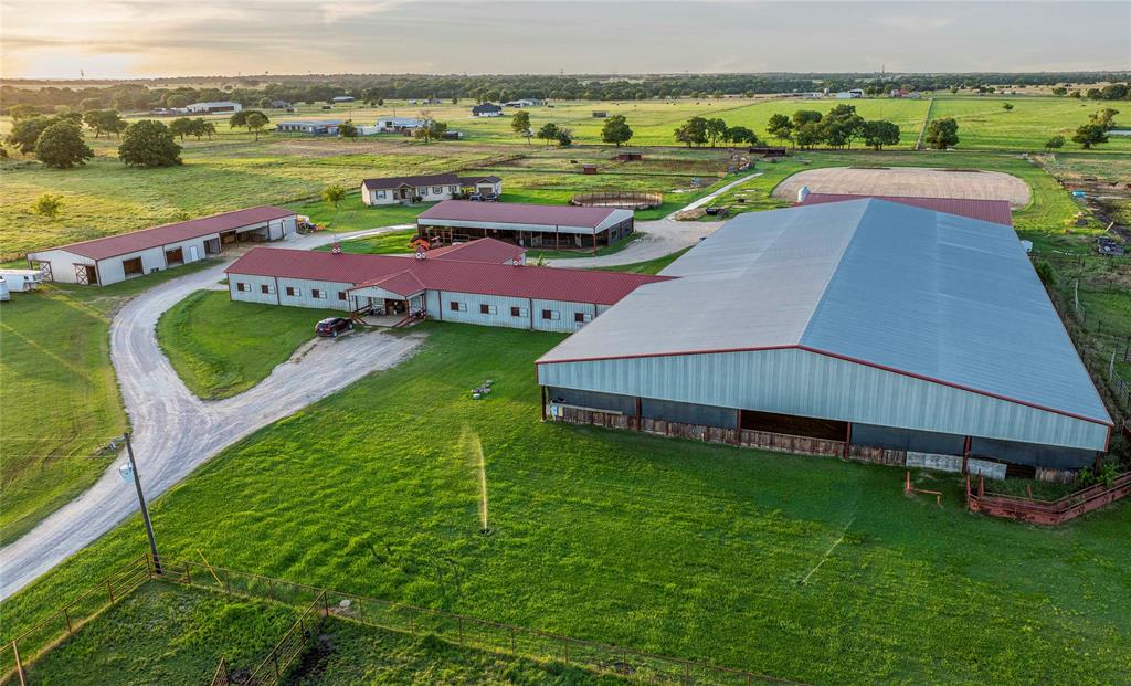 Located in the heart of North Texas horse country, this 35-acre equestrian training facility in Grayson County is designed for an established or expansion-ready horse operation. The property is fully fenced and cross-fenced with pipe and barbed wire and features a gated entrance, plumbed pastures, eight steel-frame loafing sheds, and a pond.

Improvements include a 1,600 SF modular residence with a detached 380 SF garage or workshop. The equine infrastructure consists of three primary barns: an approximately 8,000 SF show barn with 21 stalls, observation area, and living quarters; a 7,500 SF barn with 22 stalls and an aqua therapy treadmill; and a 5,200 SF quarantine barn with 9 stalls, mare and foal harvest chute, stallion stall, 960 SF equipment shop, and 1,440 SF hay barn.

Training amenities include a 60-foot outdoor round pen, a 6,000 SF covered round pen with panel walker, outdoor arena, and a 125x250 covered arena totaling approximately 31,250 SF, allowing year-round use. Utilities include electricity, city water, well water, septic system, and feed bin.

Convenient access to US 82, TX-377, TX-289, Dallas North Tollway, and I-35. Additional 62 contiguous acres available for separate purchase.