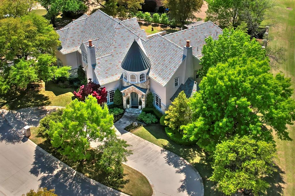 Exceptional French-inspired home with a modern flair, located in the 24-hour gated golf course community of Mira Vista. Stunning remodel in 2020 with one of a kind architectural features and details. The open-concept kitchen, living, and dining spaces provide a seamless flow for both everyday living and grand entertaining. An elegant office, chic wet bar, and cozy den offer versatile spaces, while the LUX magazine-featured kitchen is a chef’s dream—complete with top-tier appliances and custom finishes that elevate the home’s aesthetic. The main floor is home to the primary suite with a private sitting area, dedicated office, large sized closets, custom marble bath with dual vanities, a freestanding tub, and glass shower. An additional guest suite and expansive laundry-mudroom complete the main level, providing ample space and functionality. Upstairs, you'll find four spacious bedrooms, two full bathrooms, an exercise room, and a media room with a bar area. What was once a three-car garage has been transformed into a sensational game room with dual HVAC units, a wet bar, and a convenient half bath. Glass doors open up to a stunning outdoor oasis, where a newly constructed pool with waterfalls and an attached spa create a resort-like atmosphere. A covered pergola adds charm and shade, making this space perfect for relaxation or hosting guests. Every corner of this home exudes sophistication, craftsmanship, and thoughtful design, offering a rare opportunity to experience luxury in one of the area’s most sought-after communities.