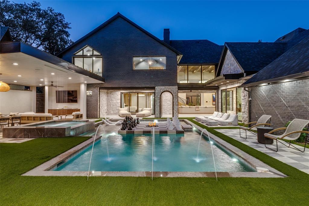 For a virtual tour: Baxtershirecom. Over 6,000 square feet of designer living space meticulously completed upgrades finished in 2025 with 5,350 sqft in the main house and 700 sqft in the back to make a total of 6,047 sqft of living space! This well designed home is an impossible find and truly one of a kind. Architecturally striking with a modern European aesthetic, this estate blends timeless design with an insane level of craftsmanship and upgrades you simply will not find anywhere else in Dallas. Elegant Venetian plaster walls, RH chandeliers, soaring 20-foot ceilings, custom stonework, reclaimed wood ceiling details, and artisan Zellige tile create a warm yet elevated feel throughout the entire home. The kitchen is an absolute showpiece featuring dramatic marble surfaces, custom cabinetry, designer lighting, and luxury finishes that carry consistently throughout every space in the house. The outdoor living experience feels more like a private resort than a backyard. A stunning pavilion with lounge areas, an outdoor kitchen, and a pizza oven that overlooks the heated pool, creating the perfect setup. One of the biggest differentiators of this property is the pool house and guest retreat complete with its own full bath, golf simulator, and additional flex space ideal for an office, gym, or studio. Most homes in this price range simply give you more bedrooms you don’t need. This home gives you a completely separate, high-end space you’ll actually use. Whether it becomes a private office, guest suite, or entertainment retreat, it adds a level of functionality and flexibility that is extremely hard to find. This home was intentionally designed and heavily upgraded to create something elevated, custom, and genuinely unforgettable. The home itself has 5 bedrooms, a family room that could be an office or a 6th bedroom, and an additional room being used as a gym. The house has 3 full bathrooms and 2 half bathrooms with the 4th full bathroom located in the pool house.