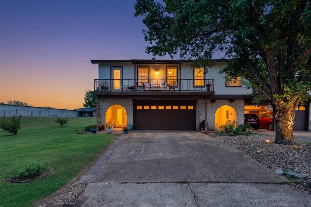 Welcome to resort-style living in the prestigious gated community of DeCordova Bend Estates! This beautifully updated 2BD, 2.5BA townhome delivers 1,530 sq ft of effortless comfort. The large inviting living room sets the tone with a stone fireplace, archways, rich wood laminate floors, and an abundance of natural light — the perfect space to relax or entertain. The renovated kitchen is a showpiece with painted cabinetry, newer hardware, gleaming granite countertops, stainless appliances, classic subway tile backsplash and a charming window above the sink. Both bedrooms are generously sized, with the primary suite offering the luxury of two closets. Refreshed bathrooms throughout, plus a convenient guest half bath that keeps your private spaces just that — private. Step through the sliding glass door onto the large covered back patio — your personal retreat for relaxing in the shade on warm summer days. The landscaped flowerbeds and low-maintenance yard add curb appeal without a lot of upkeep. A fenced backyard with a gate that opens directly to the community playground, pool, and clubhouse — it's like having a resort in your backyard. Head upstairs and step onto the front balcony for a breathtaking peek at the lake on crisp winter days. And for the golf enthusiast, the oversized 2-car garage plus large golf cart garage with extra storage has you covered — with the marina and golf course just moments away. DeCordova Bend Estates offers a truly unmatched lifestyle: 24-hour gated security, pickleball, volleyball, tennis, basketball, and so much more. This is lock-and-leave living at its finest — just move in and enjoy everything this incredible community has to offer!