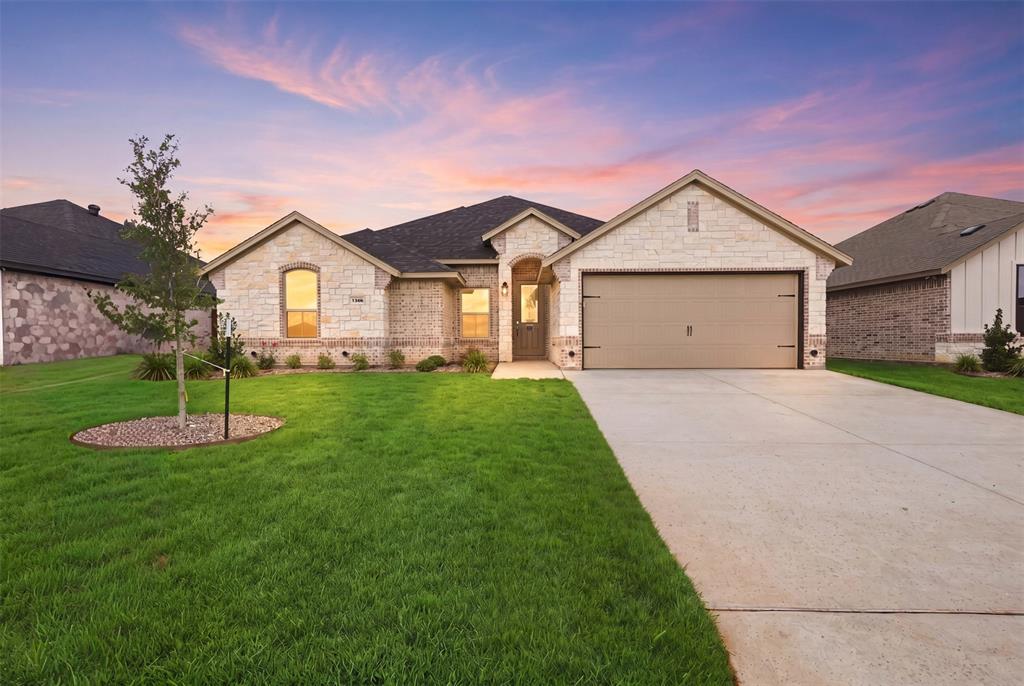 Located in the desirable Parks of Tolar community, this move-in-ready home by Al Couto Homes combines quality construction with upgraded finishes throughout. Wood look tile flooring, crown molding, granite countertops, and stylish details create a clean, modern feel from the moment you walk in. The open concept living area is bright and inviting, centered around a stone fireplace that adds warmth and character. The kitchen is designed for both function and flow, featuring granite countertops, stainless steel appliances, and a breakfast area with views of the backyard. The primary suite offers a private escape with dual sinks, a walk-in shower, a soaking tub, and a spacious walk-in closet. A split bedroom layout provides flexibility and privacy for guests or family members. Step out back to a covered patio with enough space to relax or entertain. Additional features include spray foam insulation for energy efficiency, granite surfaces throughout, crown molding, and an epoxy-coated garage floor. Located near top-rated Tolar ISD schools with easy access to parks, shopping, and daily conveniences, this home delivers a solid mix of comfort, efficiency, and thoughtful design.
