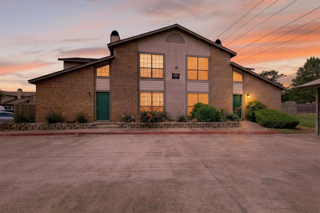 Come see this beautifully updated 3-bedroom, 2-bath condo tucked away in a private area of the community, backing directly to a peaceful greenbelt for added privacy. Step inside to find soaring vaulted ceilings in the spacious living area, complete with a cozy wood-burning fireplace—perfect for relaxing or entertaining. The home features new flooring on the first floor, creating a fresh, modern feel from the moment you walk in. You’re sure to love the updated kitchen that shines with stylish finishes and ample space for cooking and gathering. The thoughtfully designed layout includes one bedroom and a full bath on the lower level, ideal for guests or a home office, while upstairs features two additional bedrooms and a full bath, highlighted by a newly renovated primary shower that adds a touch of luxury to your daily routine. Enjoy your own private patio on the first floor overlooking the greenbelt, perfect for quiet mornings or unwinding in the evening, plus access to community amenities including a pool and clubhouse and many parks nearby! Conveniently located near major highways, shopping, dining, and just minutes from DFW Airport, this home makes for effortless living in the heart of DFW!