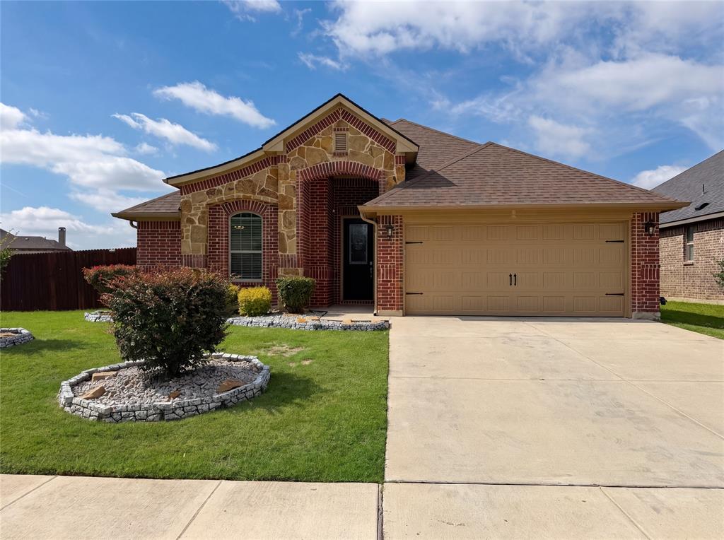 Welcome to 709 Ravenwood Dr, recently refreshed with fresh interior paint throughout. The kitchen is equipped with all stainless steel appliances, an accent backsplash, and a functional island, while a fireplace provides a central feature. The primary bathroom includes double sinks and a separate tub and shower, complementing the covered patio and fenced in backyard. Experience updated style and seamless outdoor living. Home comes with a 100-Day Home Warranty and a 7-Day Home Test Drive to move in 7 days early for free