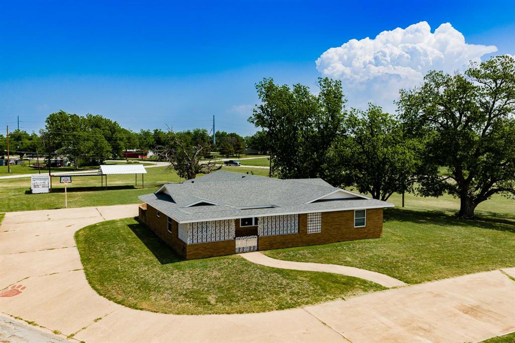 Perched atop a hill in Seymour, Texas, this beautiful pier and beam shiplap house with brick overlay offers stunning views overlooking the city park and the charm of small-town living. Situated on a full city block with mature trees and scenic surroundings, this property truly stands out with space to live and grow. The main home features 3 bedrooms and 2 bathrooms, including a spacious primary suite with a walk-in closet. Two inviting living areas provide plenty of room for relaxing or entertaining. Enjoy incredible hilltop views and a prime location near the school and hospital.
Additional highlights include a water well pump, mature pecan trees, two pear trees, and a fig bush all maximum producers. The roof is less than 2 years old. Adding exceptional value, this property includes a separate mother-in-law suite as well as a one-bedroom tiny house apartment, ideal for multi-generational living, guest accommodations, or potential rental income. This versatile space offers the perfect private retreat, hobby space, or quiet getaway, adding even more flexibility to the property. A 2-car double garage with an extra storage closet in the rear of the house provides maximum security. A decorative metal-adorned courtyard creates a striking first impression and enhances the home’s unique character. Storage container conveys with the property, and the RV port is equipped with 50-amp service. Don’t miss this rare opportunity to own a one-of-a-kind property with unmatched views, space, and income potential.