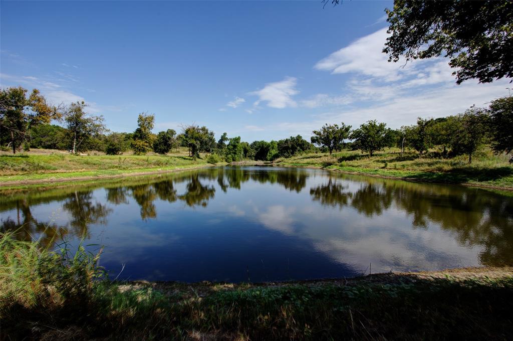 A Once-in-a-Lifetime 80-Acre Brazos River Retreat

Welcome to a truly one-of-a-kind property, 80 acres perched above the Brazos River with some of the most breathtaking bluff views you will ever find. A winding all-weather road leads you past a large, stocked pond to the heart of the land, where natural beauty and endless potential meet. 
The property is already equipped with a Trinity-sourced water well and electricity to prime bluff views! The 2000 sq foot insulated shop features a 10 foot overhang and can manage the ranch equipment and storage needs.
The landscape offers remarkable variety: rolling pastures currently in hay production, stands of mature hardwoods, native vegetation for prime hunting, and even harvestable stone for your custom projects.
For riverside living, enjoy direct road access to over 800 feet of Brazos River frontage, complete with a multi-level custom rock patio, with water, and electricity ideal for unforgettable gatherings and weekends by the water. 
This is more than just land; it’s a generational investment, one that not only builds value over time but creates lifelong memories.
Located between two historic towns, Granbury and Glen Rose, with convenient highway access, you’re just minutes from dining, shopping, and recreation—allowing you to enjoy both the peace of rural living and the amenities of two vibrant communities.