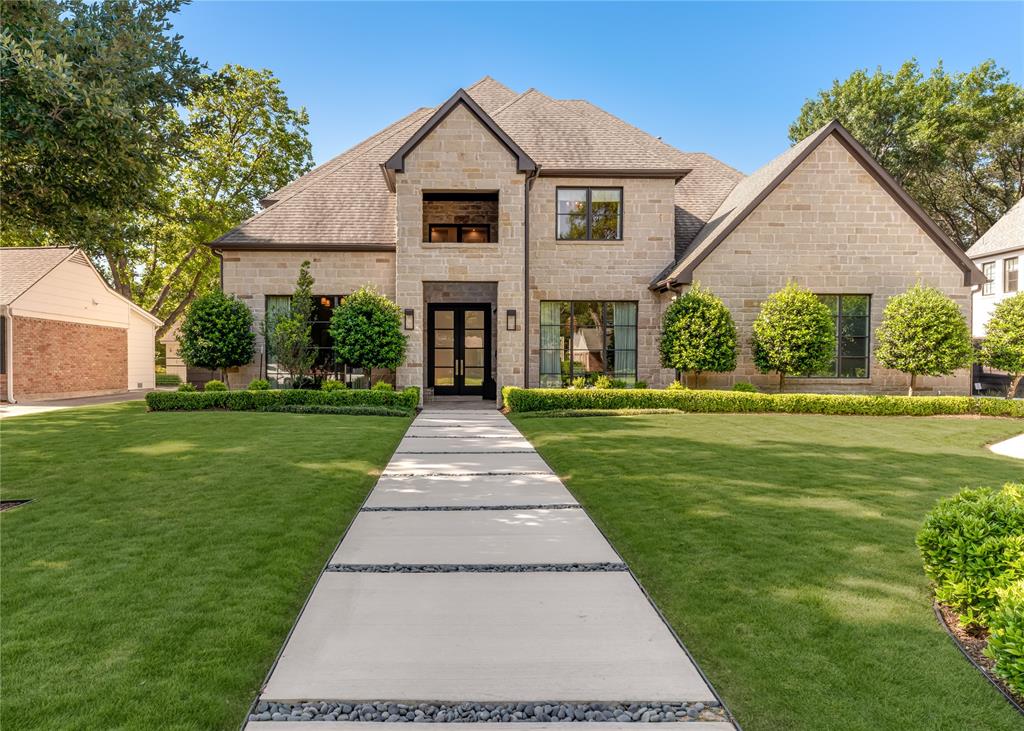 This distinguished residence has been extensively refreshed with 2025 interior updates by designer Susan Riddle, blending timeless elegance with a fresh, current aesthetic. Major improvements include a fully reimagined primary bath & chef’s kitchen, elegant French bar, & beautifully updated secondary baths. Designed for both daily living and effortless entertaining, the chef’s kitchen is anchored by an oversized quartzite island with abundant storage & adjoining catering area with 2nd dishwasher & private exterior access. A sophisticated wet bar features a dramatic bookend quartzite wall, French bar, ice maker, & 100-bottle wine refrigerator. The downstairs media room features surround sound & custom media seating. An executive office with coffered ceiling & custom built-ins offers an ideal work-from-home setting. The 1st flr primary suite is a true retreat, featuring a luxurious Thassos and Calcatta Bluette marble bath with soaking tub, oversized shower, & dual expansive closets, one complete with vanity & packing island. A private downstairs guest suite provides comfort for visitors, while an additional flexible bonus room is ideal for a gym, secondary office, or creative studio. Upstairs are 2 additional ensuite bedrooms, a cedar closet, & a spacious game room with adjoining study area. The resort-style backyard is anchored by a 41-foot heated pool. A covered loggia with automatic screens, built-in gas grill, & fireplace opens to an expansive turfed yard, creating exceptional year-round outdoor living & entertaining space. Additional amenities include whole-home generator, Sonos audio throughout, security camera system, designer lighting, draperies, wallpaper, & hardware, plus new driveway & walkway. Ideally positioned adjacent to the Northaven Trail, within walking distance to Preston Royal Village, & less than five minutes from Dallas’ premier private schools, this masterfully updated home offers refined living in one of Dallas’ most coveted neighborhoods.