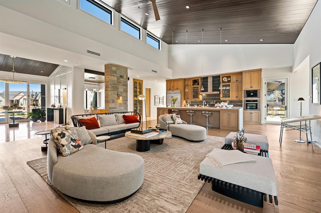 Tucked away on a coveted corner lot in Trifecta Estates, lies this modern ranch gem. One story open-concept, seamless living flows across the large family area and 4 spacious bedrooms. Professionally curated, this home boasts many one-of-a-kind touches: from custom 21’ family area ceilings, to one-of-a-kind Arteriors light fixtures, hand-made flooring, a complete Miele kitchen package, plenty of space for art, no detail is overlooked. With a designated office, exercise space, completely enclosed patio - ideal for a dog run, aviary or private garden, and a variety of outdoor living space. The peaceful and private back yard features a pond, an RV Barn and workshop storage space, and chicken enclosure. With no other residential development on the rear of the property, it offers southern exposure to an equestrian center with horses grazing at the fenced property line. Truly unlike anything else on the local market, this home offers unparalleled style and serenity with move-in ready convenience.
