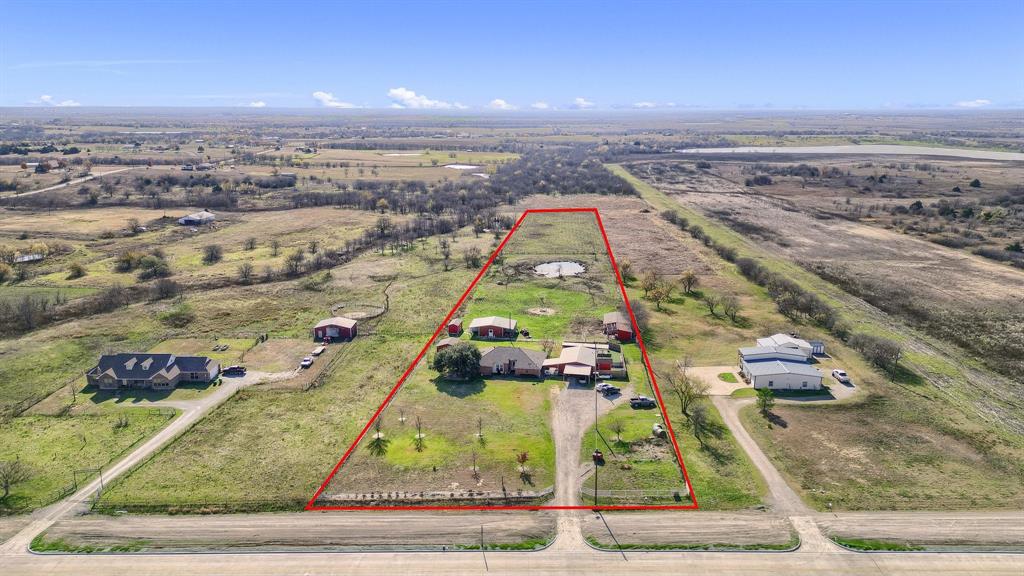 Located on the upcoming Fred Smith Parkway, nestled between the Tollway extension to the east and the forthcoming Legacy Road to the west, is a 5-acre plot of land. This property, situated merely half a mile from the DNT extension, is not presently zoned. It features a residence with additional outbuildings and faces a new residential development. The land offers numerous development opportunities.