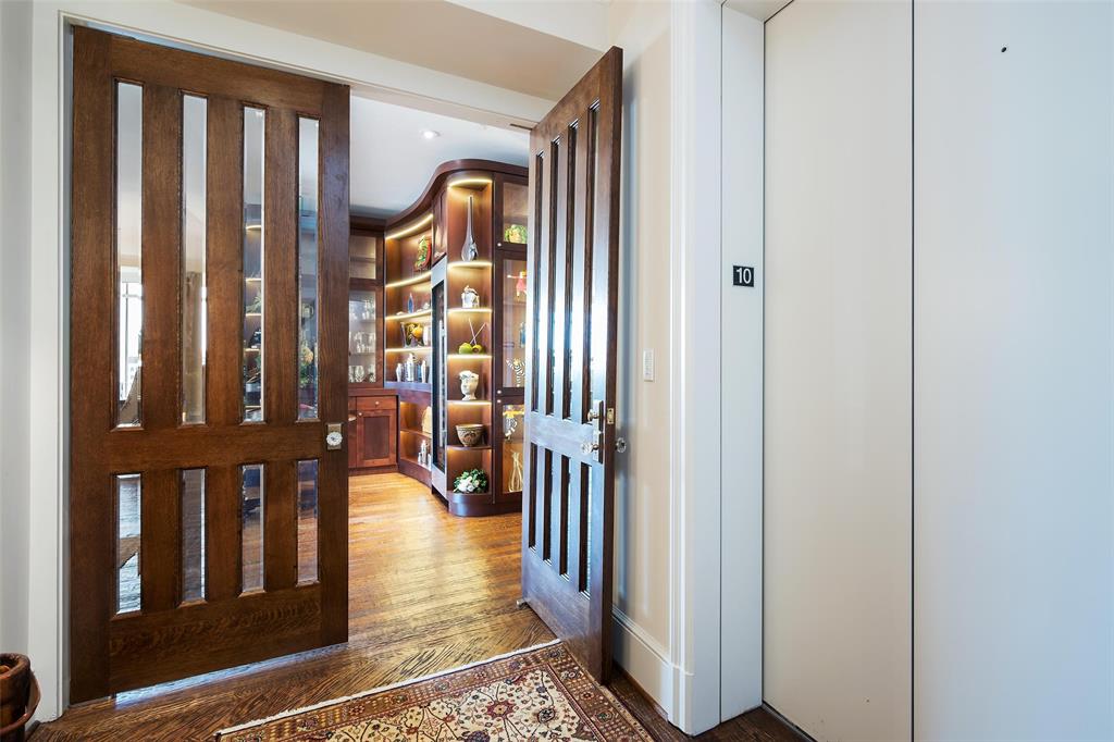 Impeccable updated 10th floor unit at the Vendome! Rich herringbone hardwood flooring throughout, a private elevator opens directly to unit. Entry leads to Living Room and adjoining Lounge which features a gorgeous cabinet with wine chiller. Split Bedroom 3, Living Room, Lounge Kitchen open to Dining all enjoy the downtown skyline and Turtle Creek Park and corridor below. Chef's kitchen with breakfast island includes Sub-zero refrigerator-freezer, 2 Subzero drawers, commercial gas cooktop and ice maker! Sumptuous suite at back has two primary baths and walk-in closet and private balcony! Nearby Bedroom 2 is privately situated. Beautiful Powder Room convenient to living areas. Full Laundry Room near Kitchen. Storage! Surfaces paint and walls 2023.