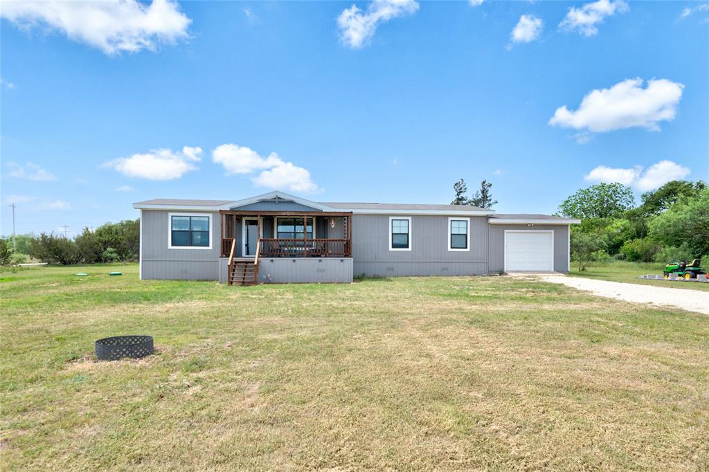 Welcome to peaceful country living in Eula School District! This charming doublewide home with land offers the perfect blend of comfort and farmhouse style throughout. Step inside to find spacious bedrooms, warm rustic touches, and a functional layout designed for everyday living. The laundry room features a convenient mud bench, perfect for keeping things organized after a long day outdoors. Enjoy your morning coffee or evening sunsets from the inviting 20x10 covered front porch. The oversized one-car garage provides extra space for storage, hobbies, or workspace needs. If you’re looking for quiet country living with farmhouse charm, this property is a must-see!