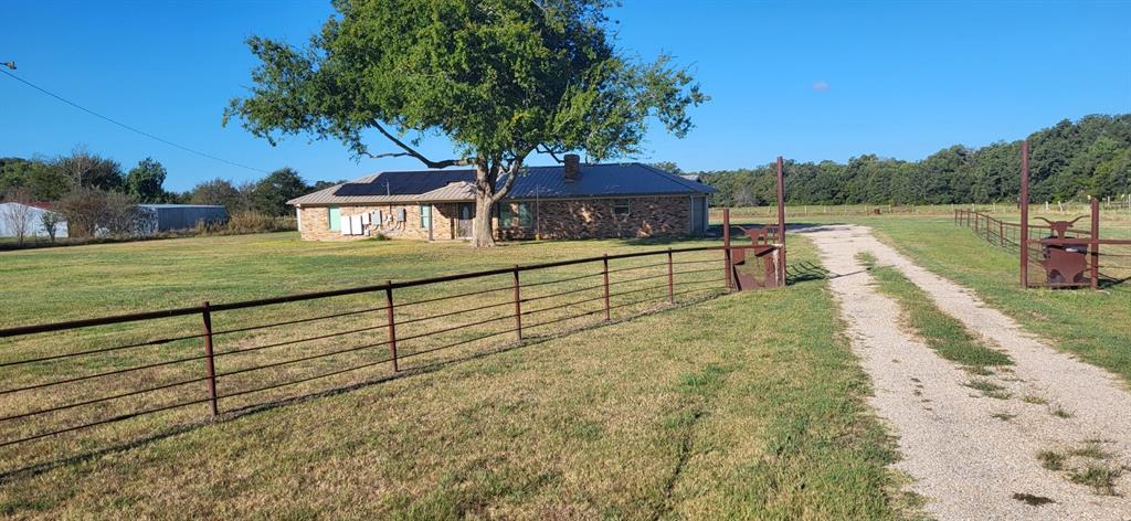 Looking for a well-maintained 3-2-4 brick home on 1.9 acres with SOLAR PANELS which means very low electric bills. Home sports an attached 2 car garage and a 24x35 attached carport, 14x24 storage building with roll up and walk thru door, wood burning fireplace (insert), granite countertops, walk in shower, metal roof, and much more.  Located between Sulphur Springs and Greenville, south of Cumby. GREAT PRICE $299,000! IF BUYER REQUIRES A SURVEY, IT WILL BE AT THE COST OF THE BUYER.