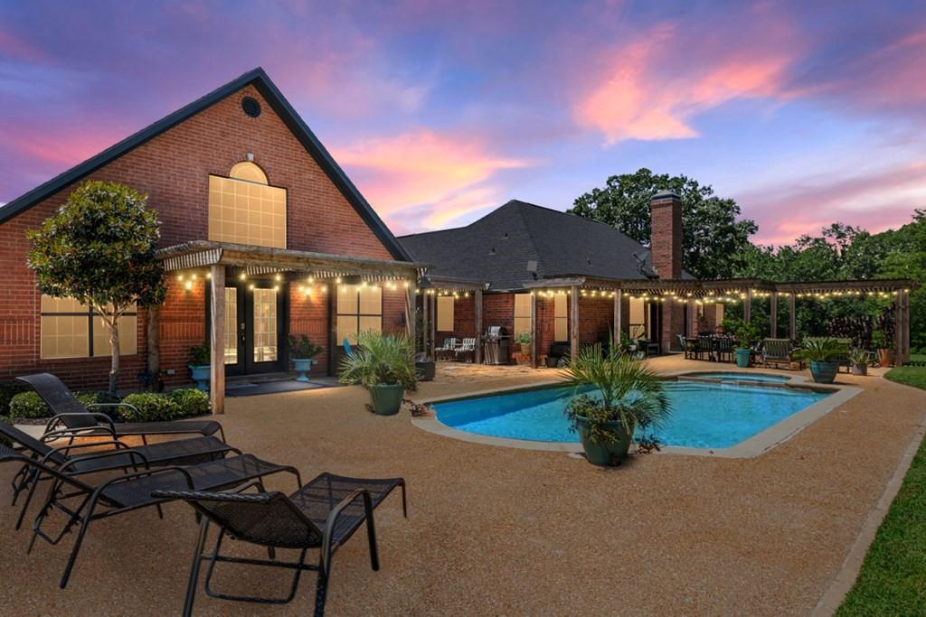 Vine & Branch Ranch has also become a well-loved site for weddings and family gatherings and photos. Its and excellent location, near HWY 198 and HWY 175 only 45 minutes from the DFW Metroplex, makes this an ideal setting for an Event Center or Winery. A Countryside Dream Estate, Over Twenty Acres of Pure Texas Living! Welcome to your retreat located in the quiet countryside, where almost twenty AG-exempt acres bring together natural charm and upscale comforts. Open pastures, grand oaks, and calm ponds set the stage for a lifestyle of tranquility, recreation, and opportunity. A picturesque tree-lined driveway leads past your private vineyard to a fully updated home, designed with meticulous care. The charming brick house boasts high-end finishes, large windows that welcome sunlight, a cozy living room with a fireplace, and a farmhouse-style kitchen. Spa-inspired bathrooms, along with rooms for crafting or media, extra storage add even more character. The main house includes 3 bedrooms with oversized walk-in closets, a loft and 2 bathrooms with a connected 3-car garage. A separate one-bedroom, one-bath guest home (900sf) comes complete with its own kitchen and generous living area, making it ideal for guests or creative pursuits. Venture outside to find a Field of Dreams – your private baseball field and lighted basketball court, perfect for family activities or evening practices. Take a dip in the sparkling pool or unwind in the hot tub, surrounded by expansive covered decking and patio spaces, ideal for gatherings. Wine enthusiasts will be delighted by the irrigated and carefully tended grapevines with over 700 plants.
