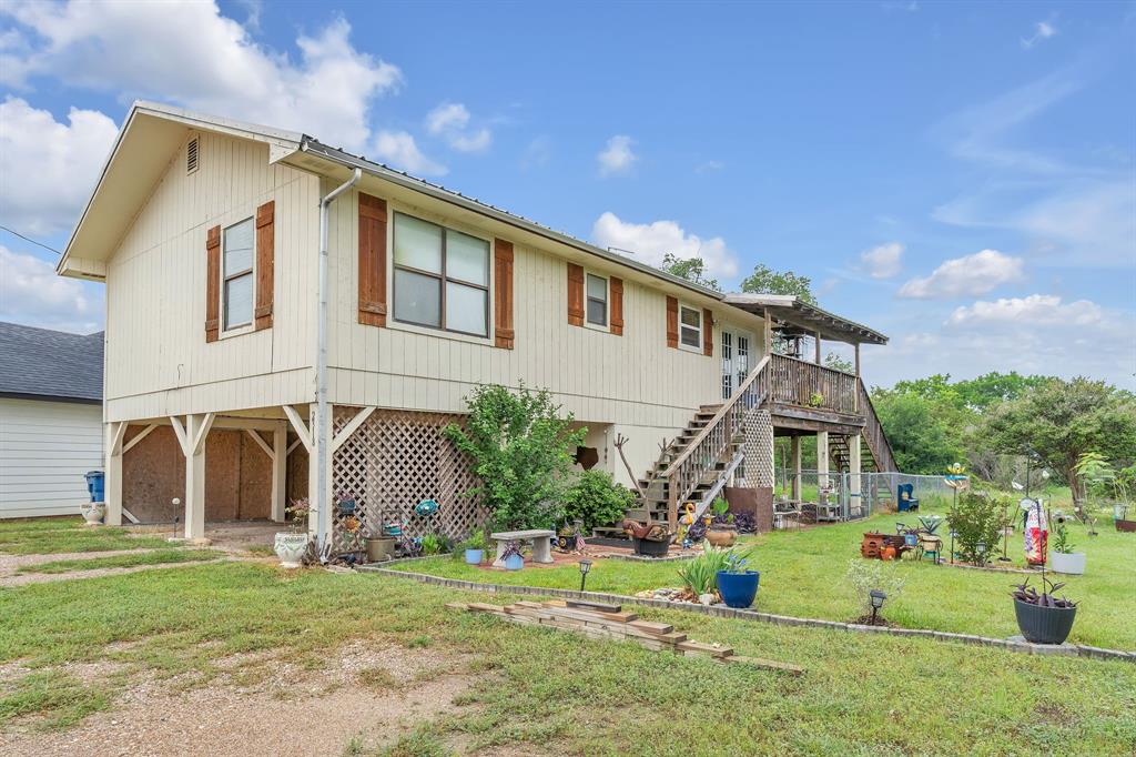 Welcome to 2318 & 2320 Neches Street (being sold together), a charming retreat tucked inside the gated Canyon Creek community just minutes from Lake Granbury. Situated on nearly an acre between the two parcels, this unique property offers the perfect blend of privacy, character, and everyday functionality.
Step inside to an inviting open-concept layout featuring vaulted ceilings, abundant natural light, and warm finishes that create a cozy, welcoming feel. The kitchen offers ample cabinetry, concrete countertops, and flows seamlessly into the main living area, making it ideal for both relaxing and entertaining.
This 2-bedroom, 2-bath home offers a flexible and functional layout, with one full bath on the main level and a second upstairs. The downstairs bath also serves as a utility space, adding convenience and practicality. On the lower level, you’ll find additional a storage area, perfect for hobbies, a workshop, or future customization.
Outside is where this property truly shines. Enjoy peaceful mornings and scenic views from the expansive covered deck overlooking the oversized backyard filled with mature trees and open green space. The elevated structure provides covered parking and additional usable space below, offering both convenience and versatility.
Located in Canyon Creek, residents enjoy gated security and access to incredible amenities including a community pool, boat ramp, clubhouse, parks, and lake access.
If you’ve been looking for space, character, and a lifestyle close to the water, this one delivers!